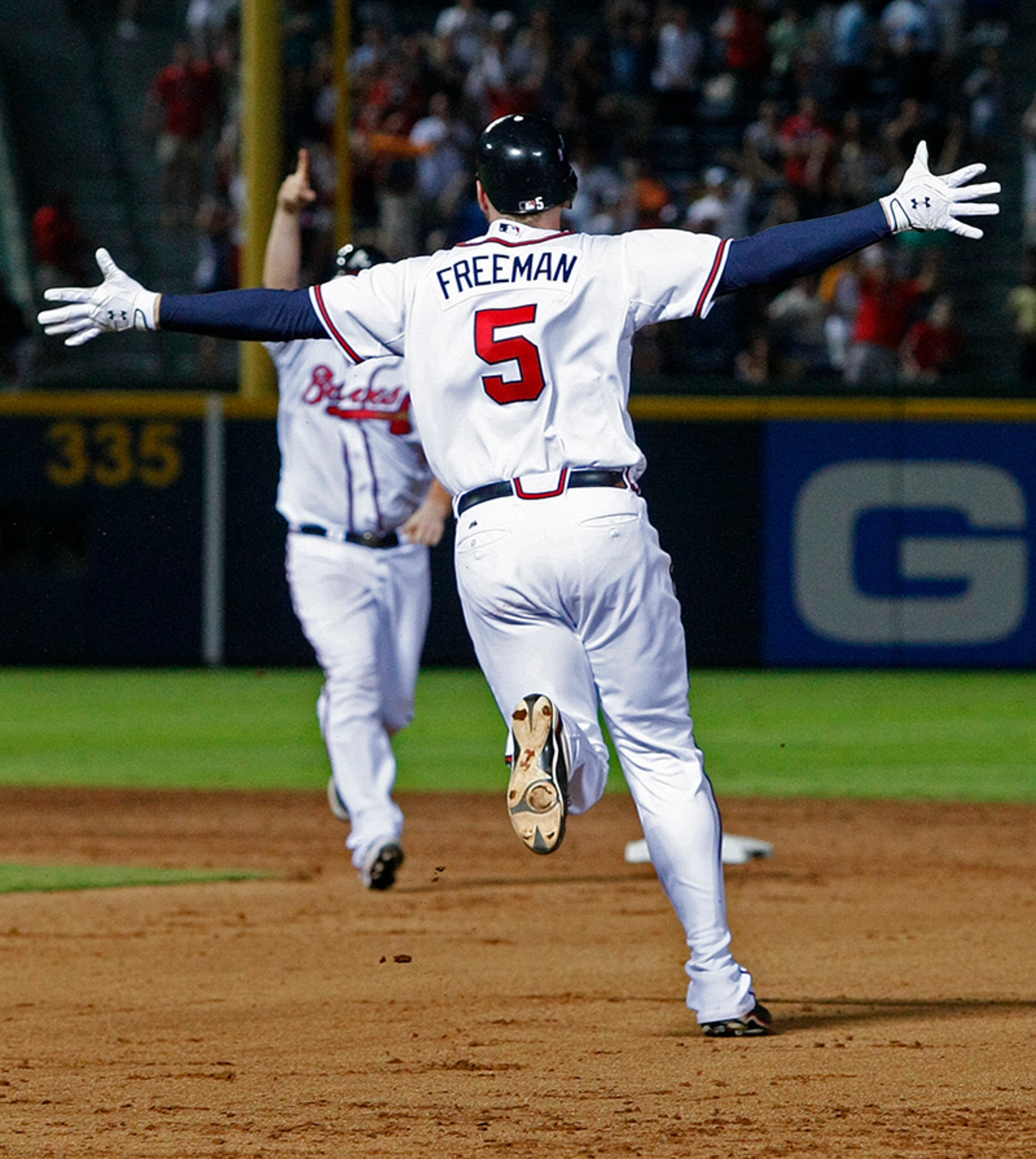 Braves first baseman Freddie Freeman rounds first base driving in the game-winning runs in the bottom of the 9th inning with a 2 RBI single to beat the San Francisco Giants 5-4 Monday, Aug. 15, 2011, at Turner Field in Atlanta.