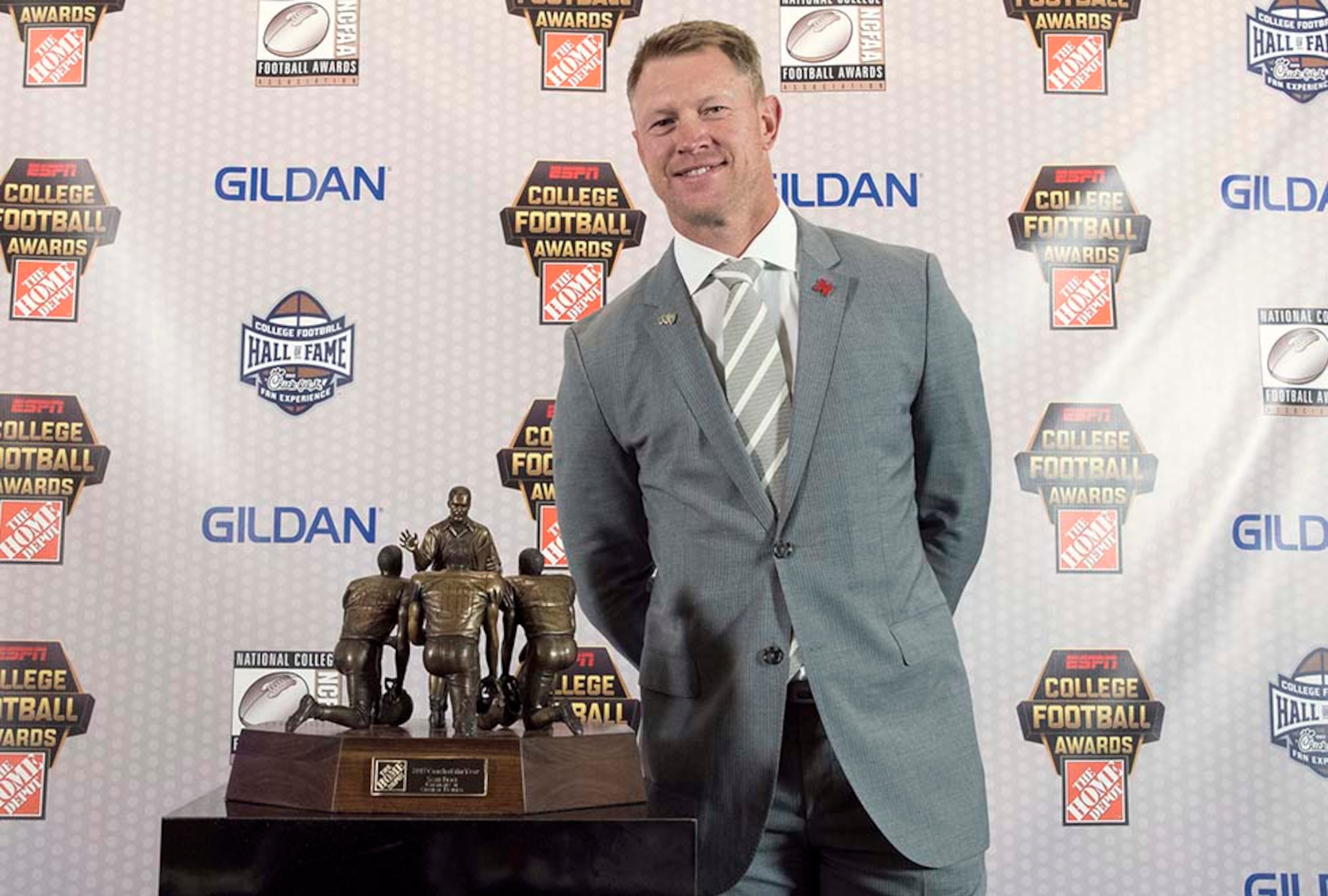 Central Florida coach Scott Frost stands with the Coach of the Year Award during the College Football Awards show at the College Football Hall of Fame, Thursday, Dec. 7, 2017, in Atlanta.(AP Photo/John Amis)