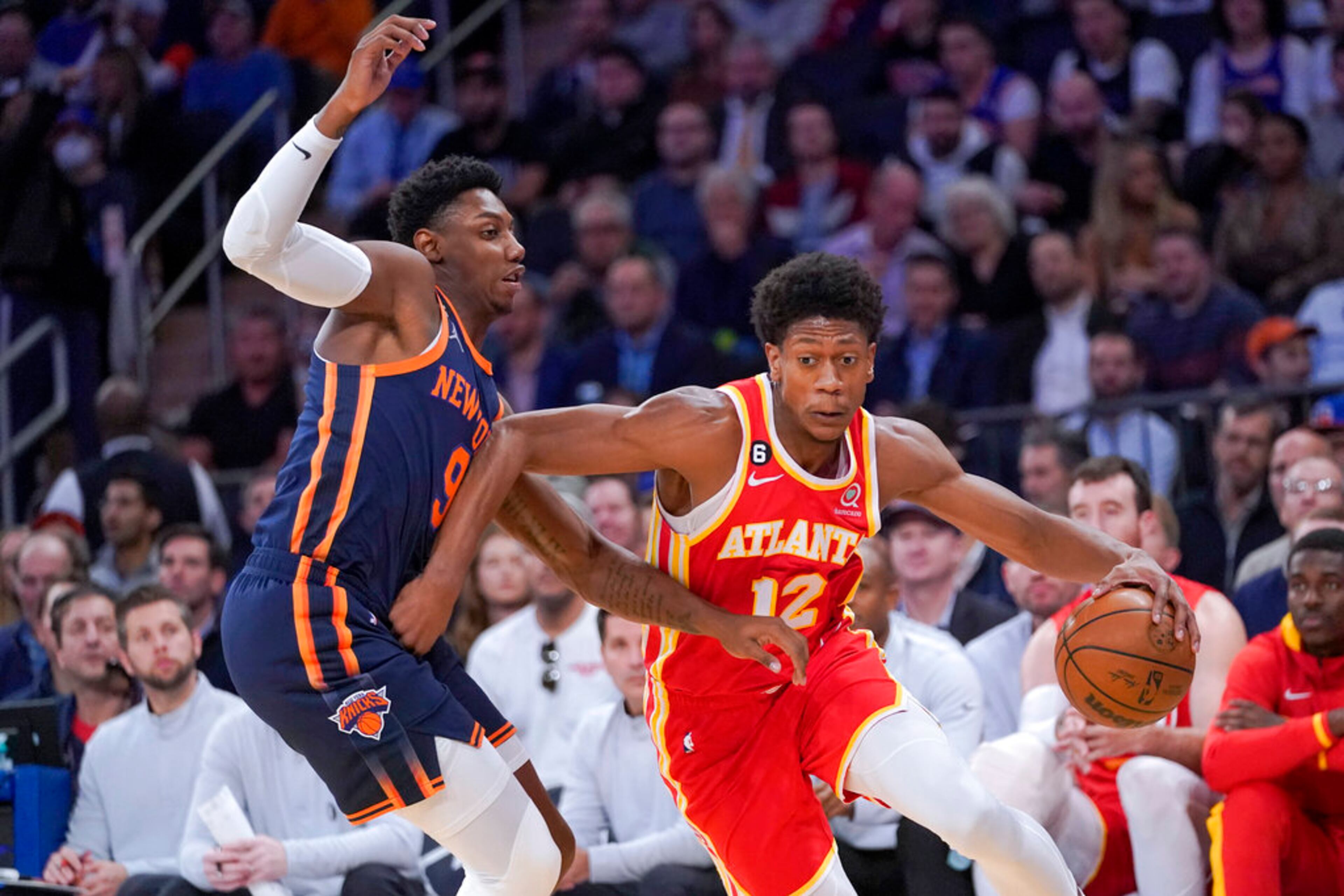 Atlanta Hawks forward De'Andre Hunter (12) drives against New York Knicks guard RJ Barrett (9) during the first half of an NBA basketball game Wednesday, Nov. 2, 2022, at Madison Square Garden in New York. (AP Photo/Mary Altaffer)