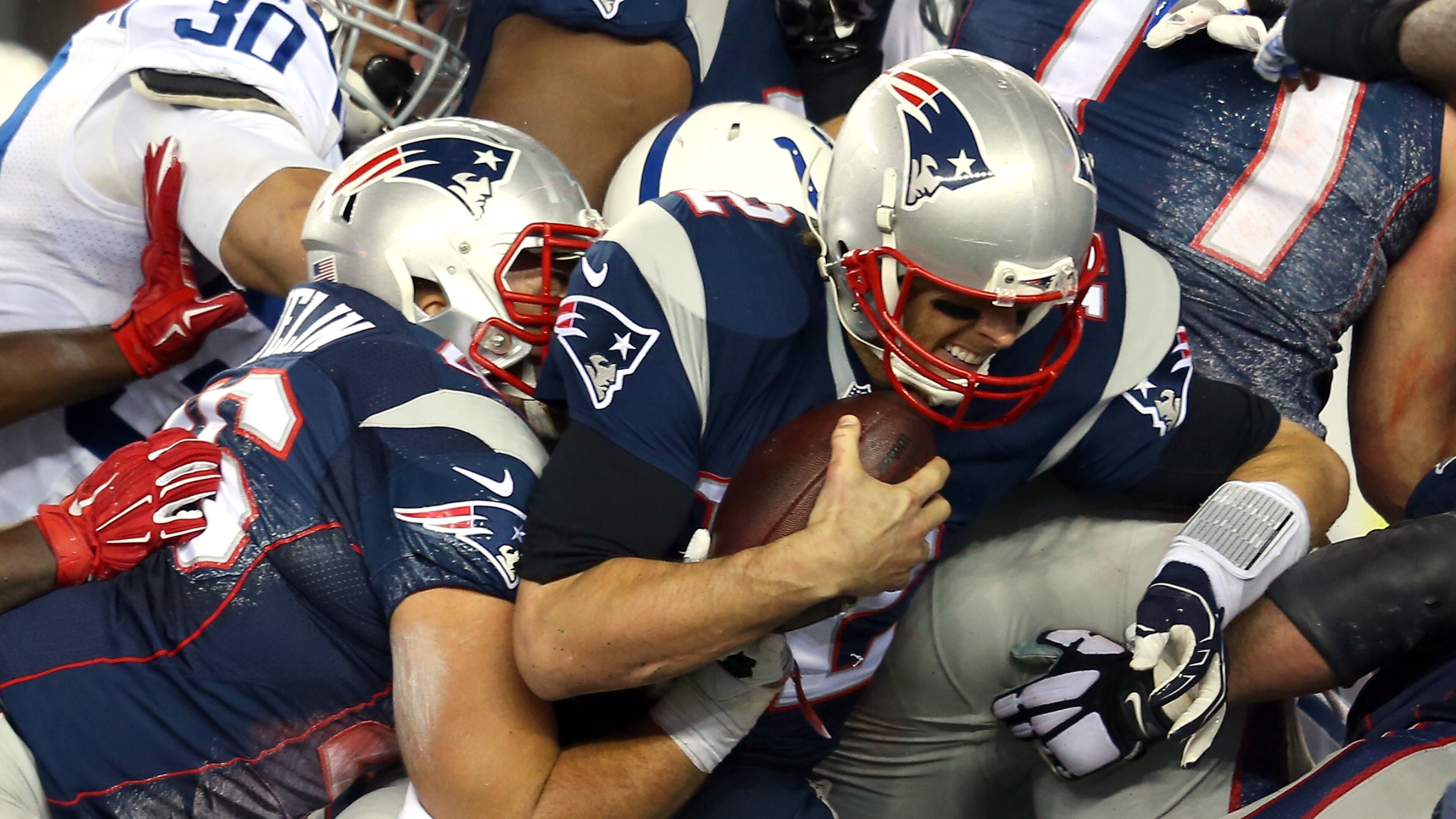FOXBORO, MA - JANUARY 18: Tom Brady #12 of the New England Patriots runs for a first down in the second quarter against the Indianapolis Colts of the 2015 AFC Championship Game at Gillette Stadium on January 18, 2015 in Foxboro, Massachusetts. (Photo by Jim Rogash/Getty Images)