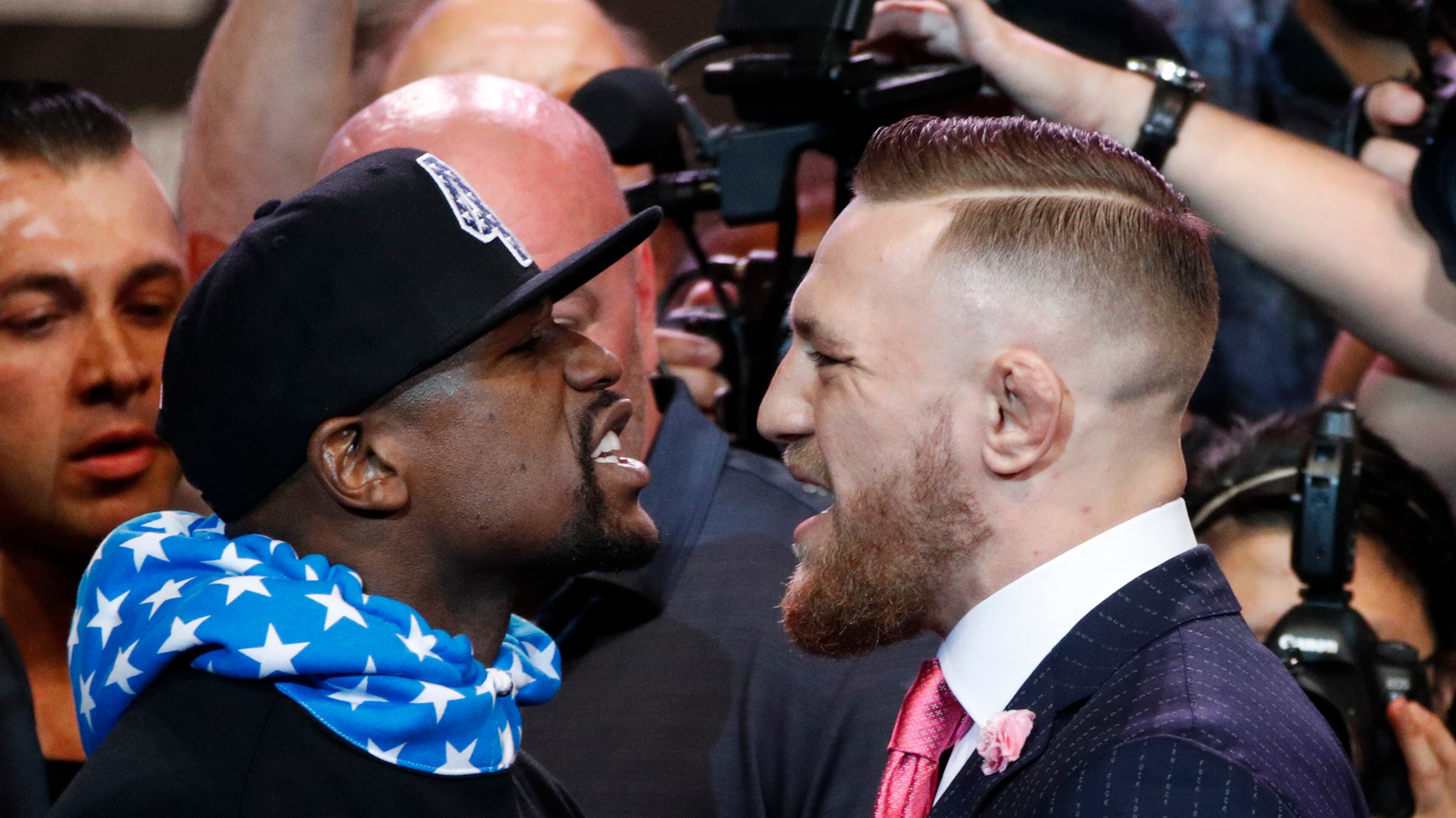 Gentlemen, start your testosterone: Floyd Mayweather Jr. and Conor McGregor face up during the Los Angeles photo op Tuesday. (AP Photo/Jae C. Hong)