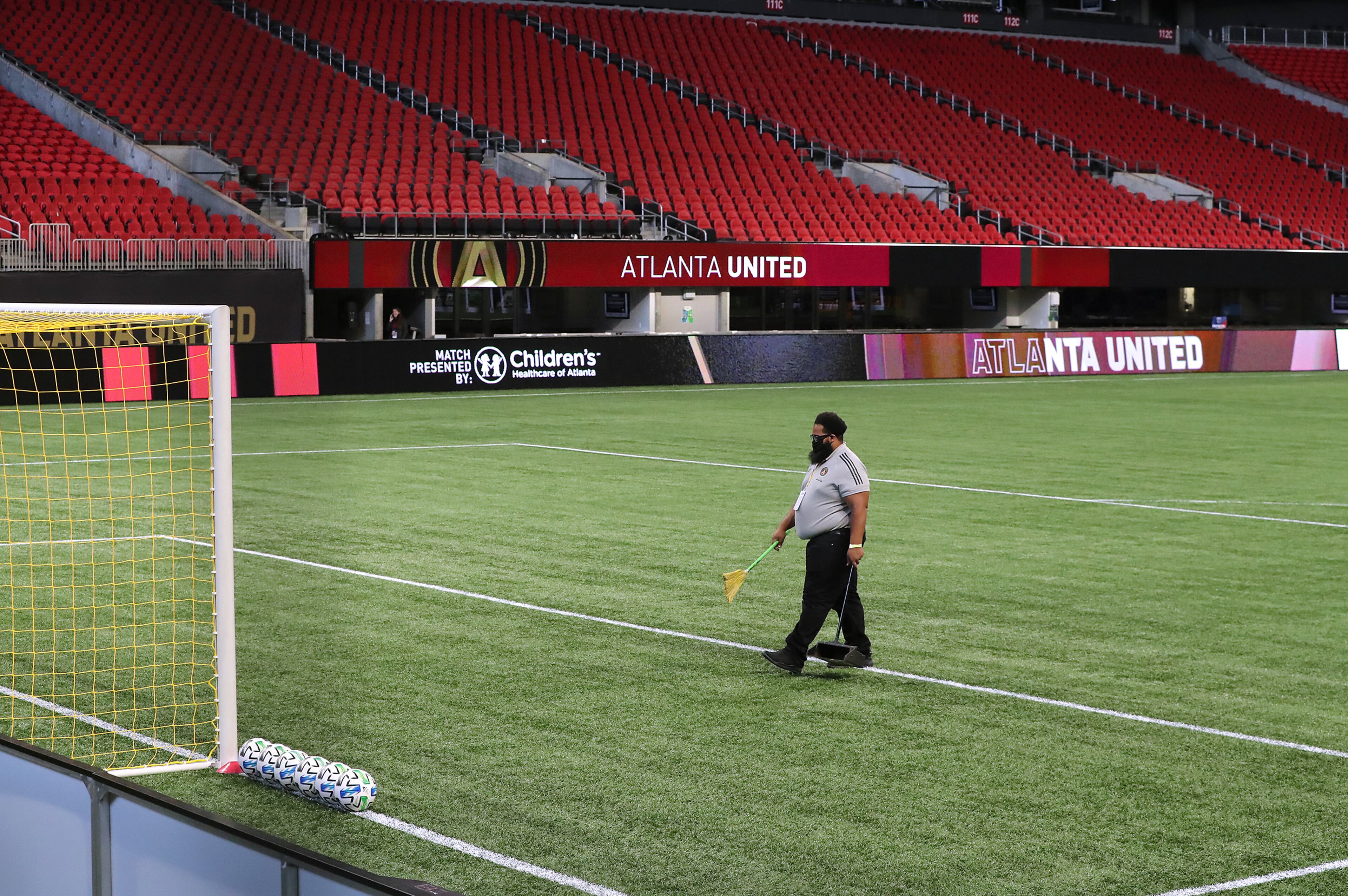 Mercedes-Benz Stadium is eerily quiet as a solitary worker prepares the pitch an hour before Atlanta United plays FC Dallas in a MLS soccer match without fans on Wednesday, Sept. 23, 2020 in Atlanta. “Curtis Compton / Curtis.Compton@ajc.com”