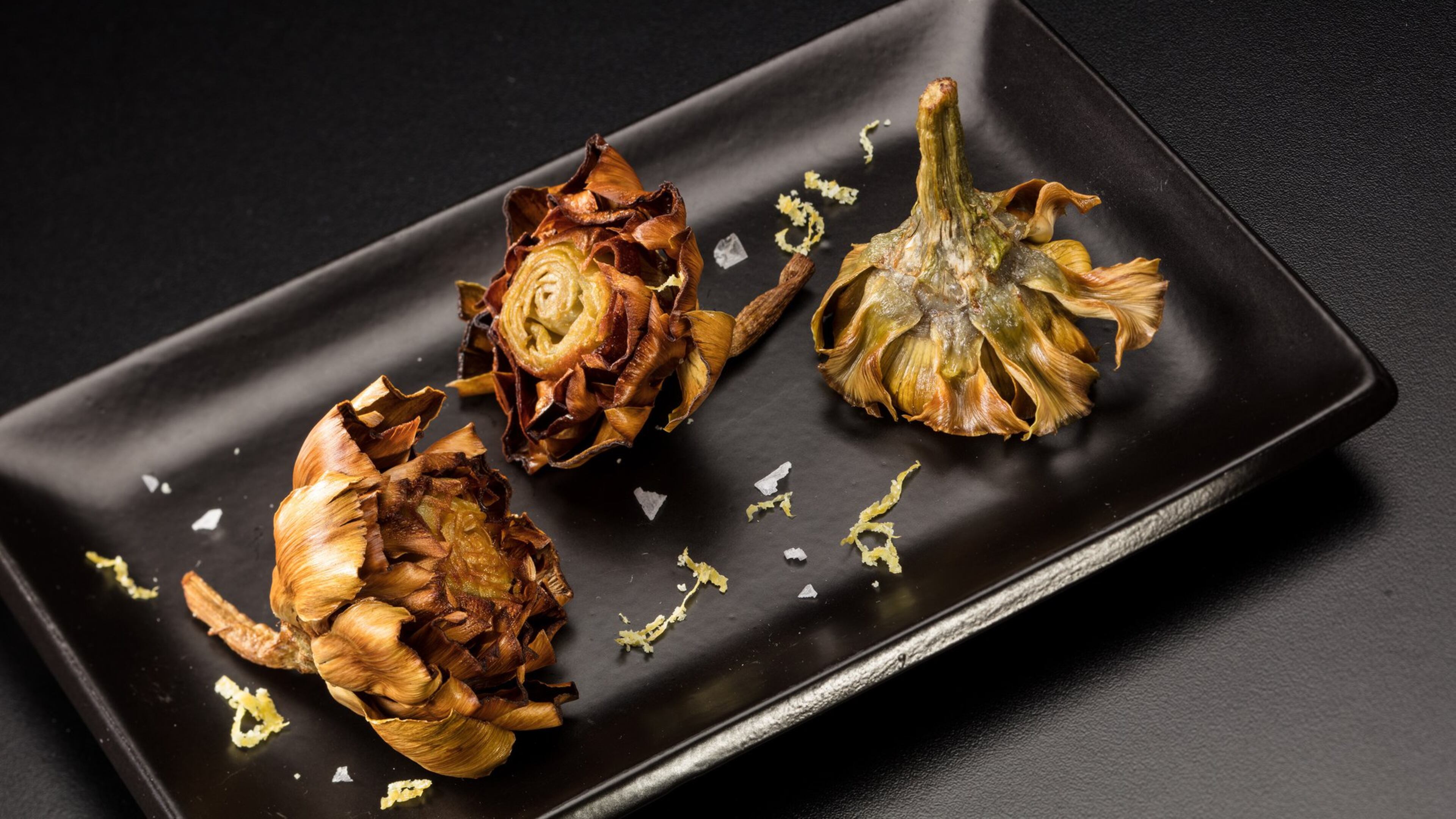 Baby artichokes are poached in oil, then crisped up in oil again before serving, sprinkled with a lemon zest and salt seasoning. (Food styling by Joan Moravek.) (Zbigniew Bzdak/Chicago Tribune/TNS)