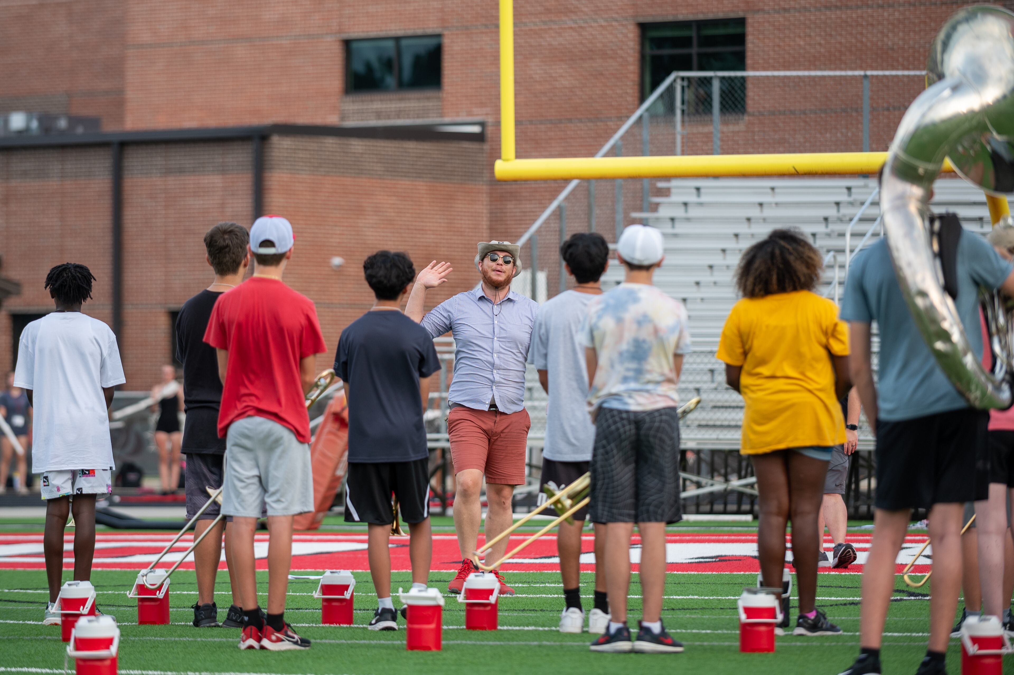 The water jugs stay nearby their owners, ready to extinguish thirst, as needed, during marching band practice at North Gwinnett High School. (Jamie Spaar for The Atlanta Journal-Constitution)