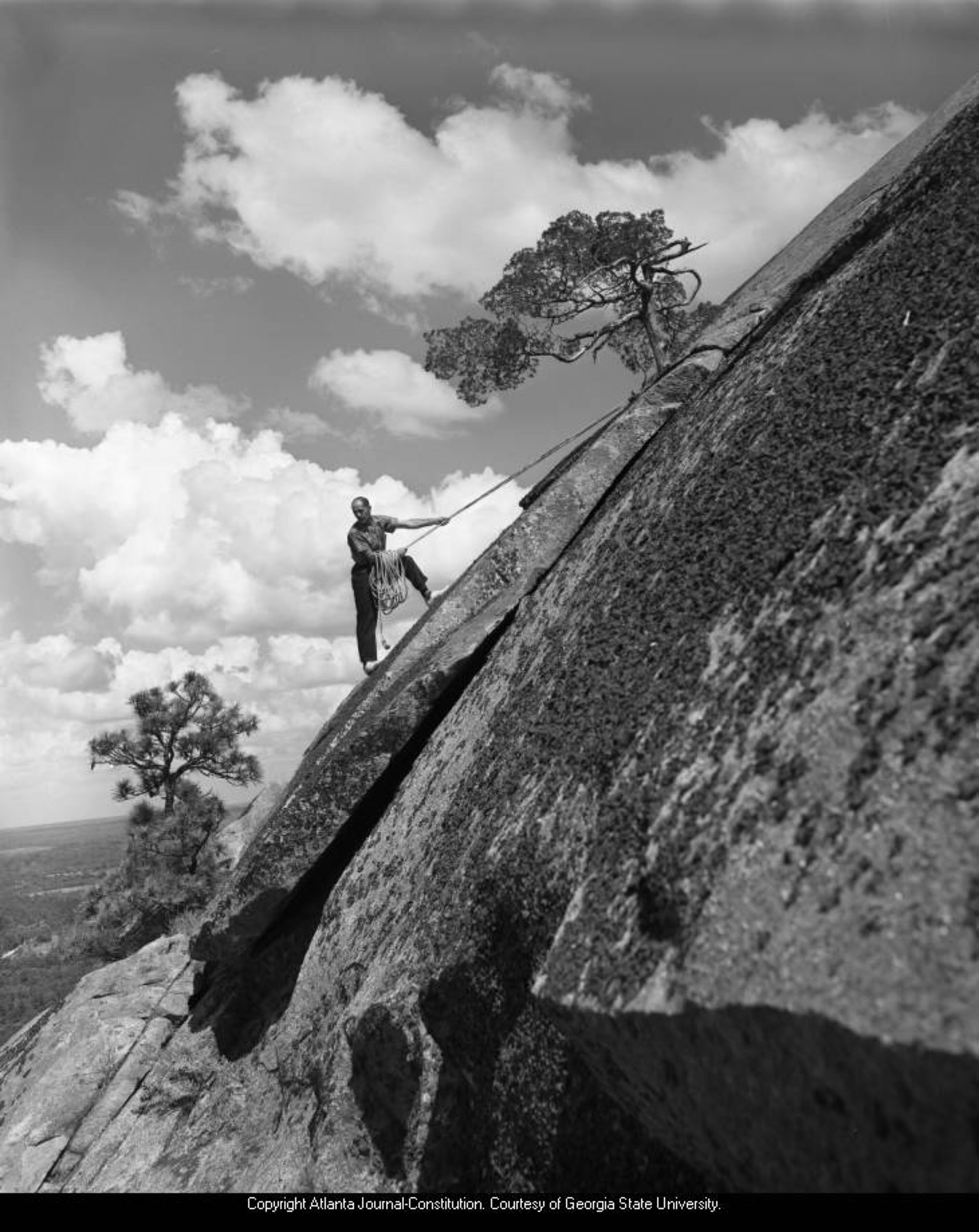 1958 -- Elias Nour climbs the steep side of Stone Mountain. KENNETH ROGERS / AJC FILE