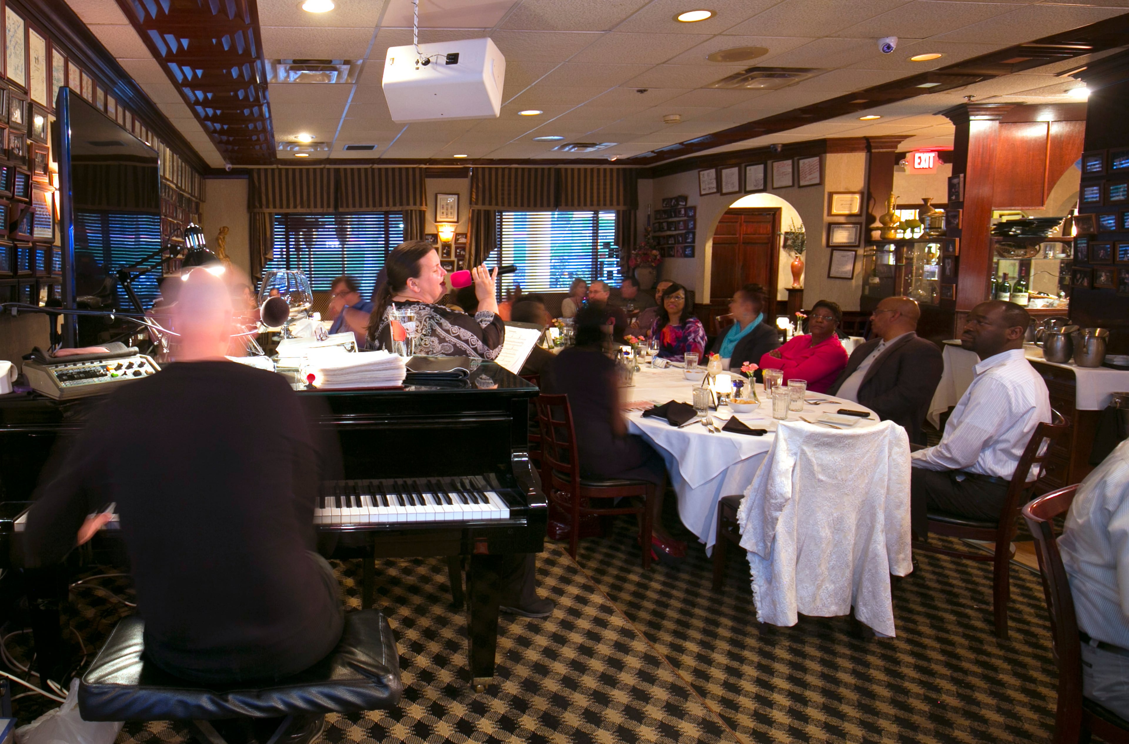 April 7, 2016 - Johns Creek, Ga: Randy Barnes, left, plays the piano as Kathe Kelner sings for customers at Altobeli's Restaurant and Piano Bar Thursday, April 7, 2016, in Johns Creek, Ga. Altobeli's Restaurant and Piano Bar is an Italian neighborhood restaurant that's served the community for over 25 years. This is for the insider's guide feature about the Newtown neighborhood. PHOTO / JASON GETZ