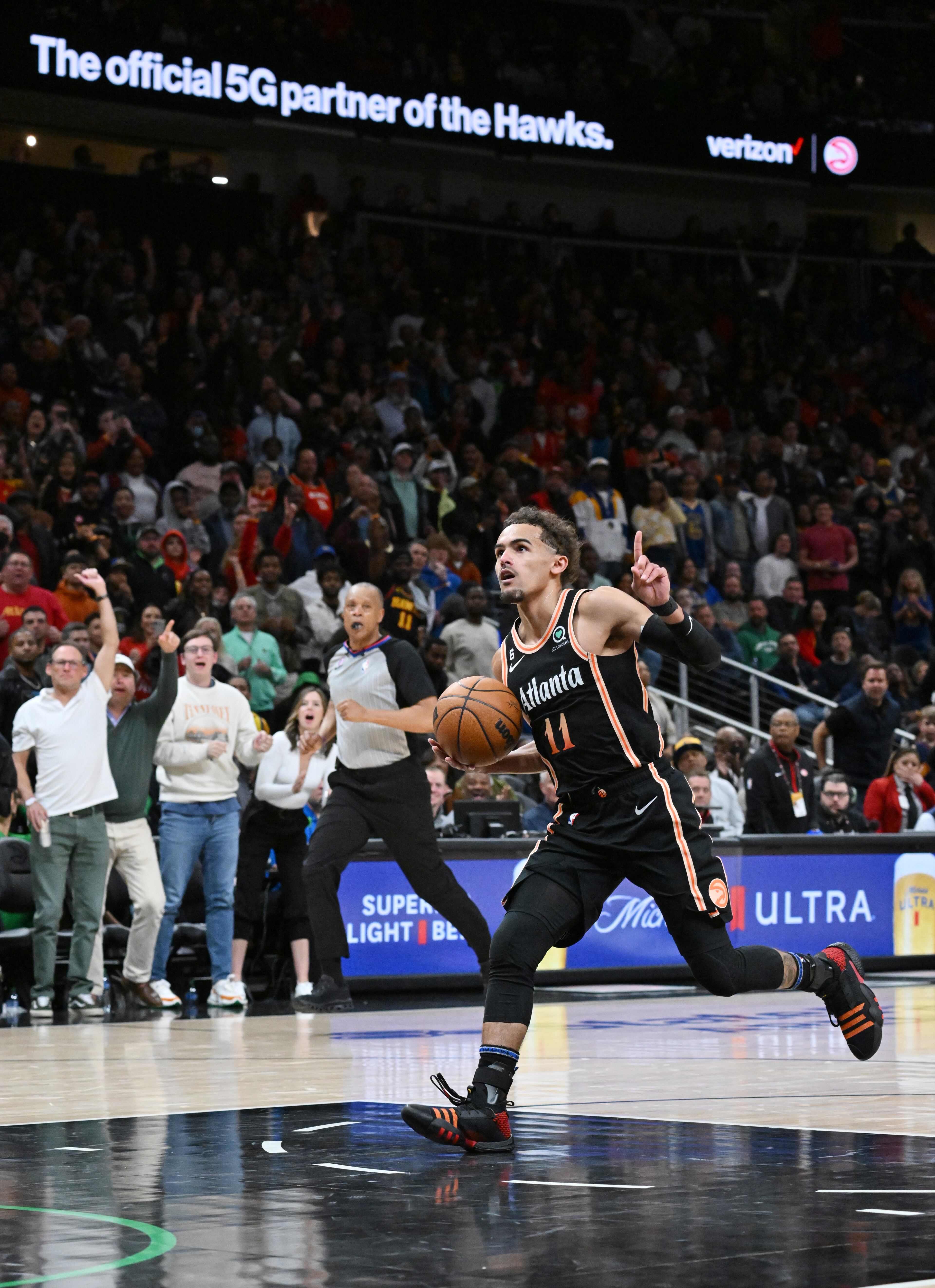 Atlanta Hawks' guard Trae Young (11) celebrates as he drives to the basket for the shot after stealing the ball from Golden State Warriors' guard Stephen Curry at the end of the game. (Hyosub Shin / Hyosub.Shin@ajc.com)