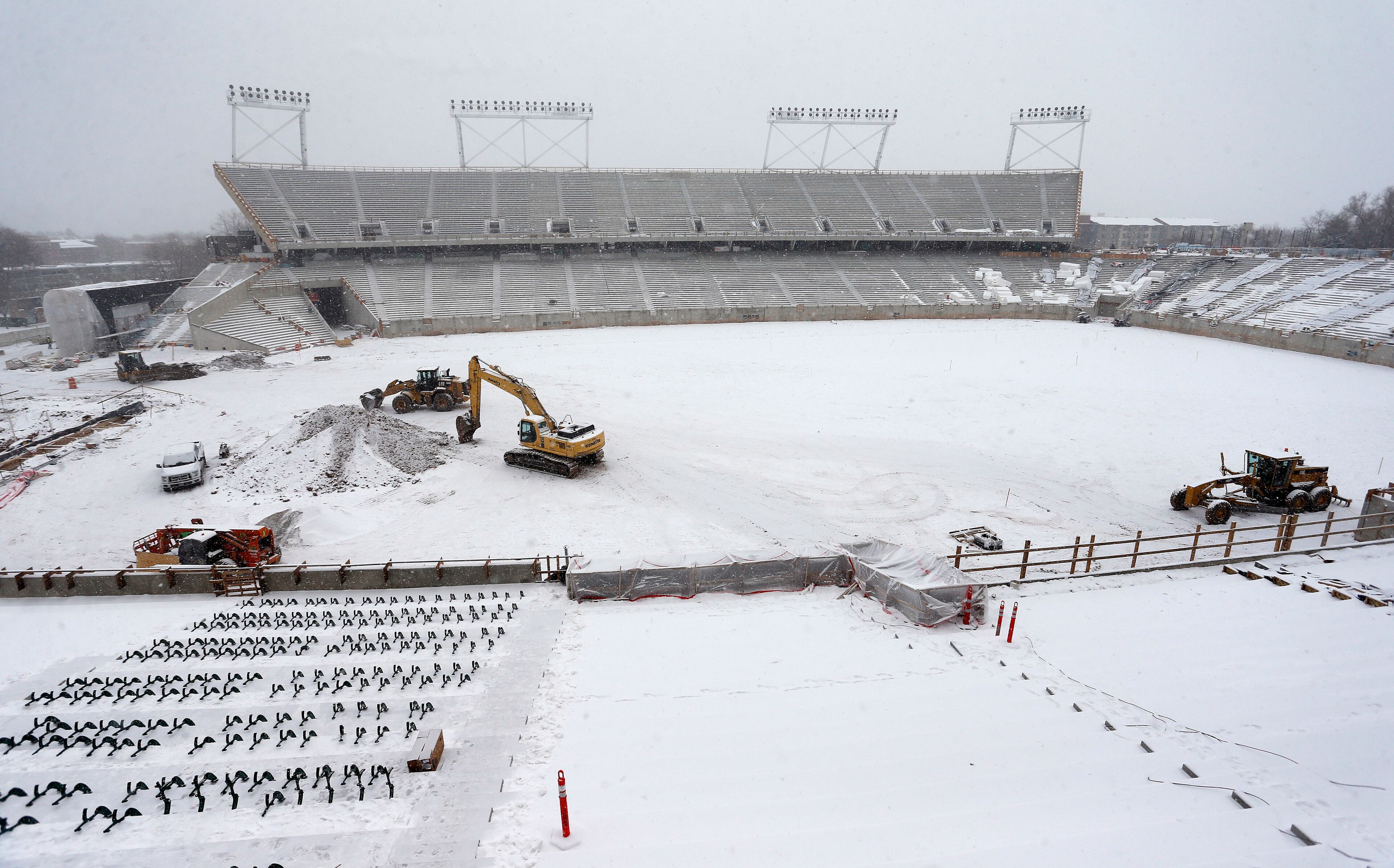 In this Jan. 4, 2017, photo, construction work continues in the snow at the site of Colorado State University's new football stadium in Fort Collins, Colo. With a new, $220 million stadium almost complete, Colorado State is one of a handful of schools that have recently committed major resources to football. (AP Photo/Brennan Linsley)