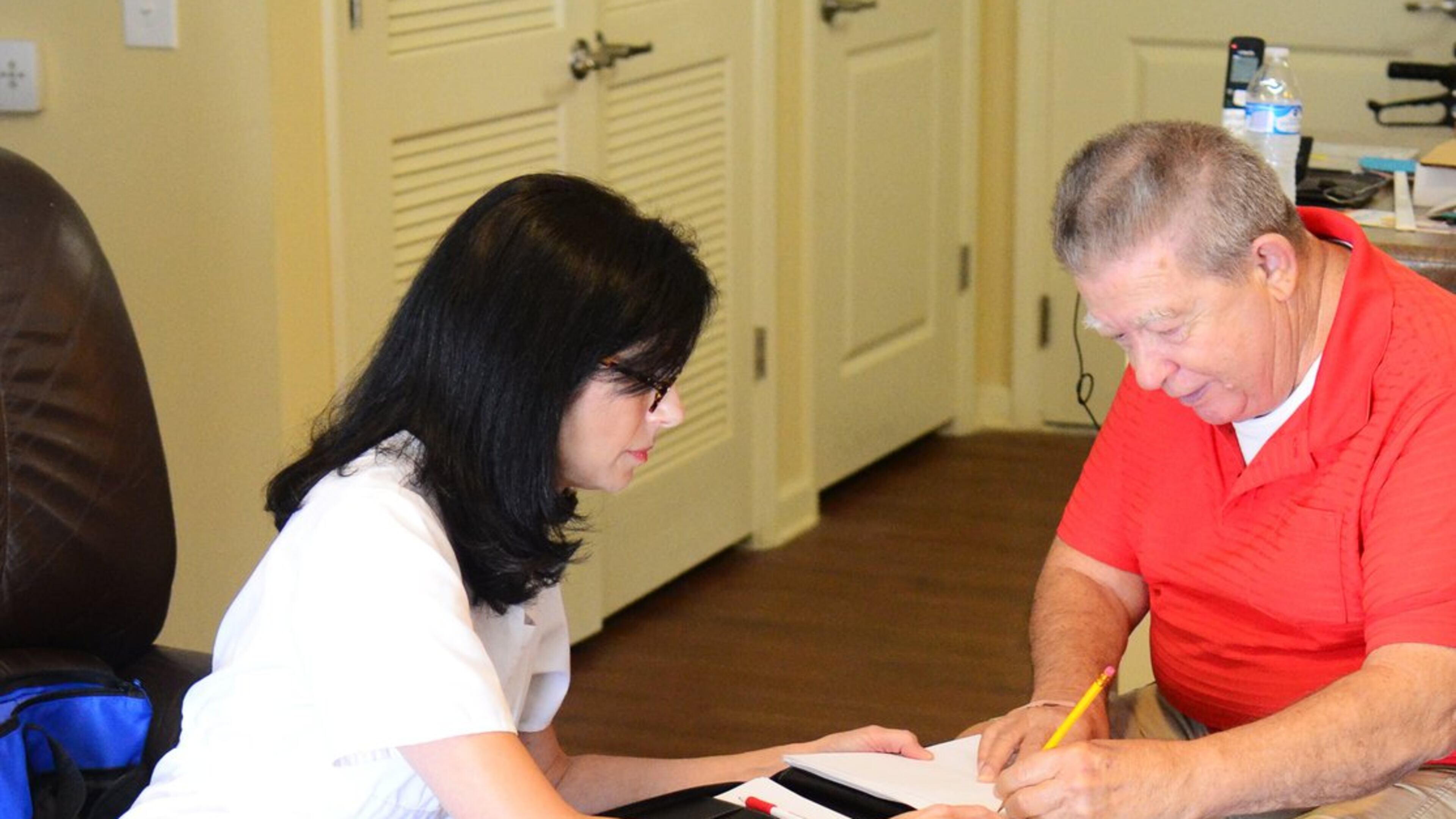 During an assessment in Gainesville, Registered Nurse Karolyn Diamond-Jones has her client, Tom Etheredge, write a sentence as part of a mental and physical test.