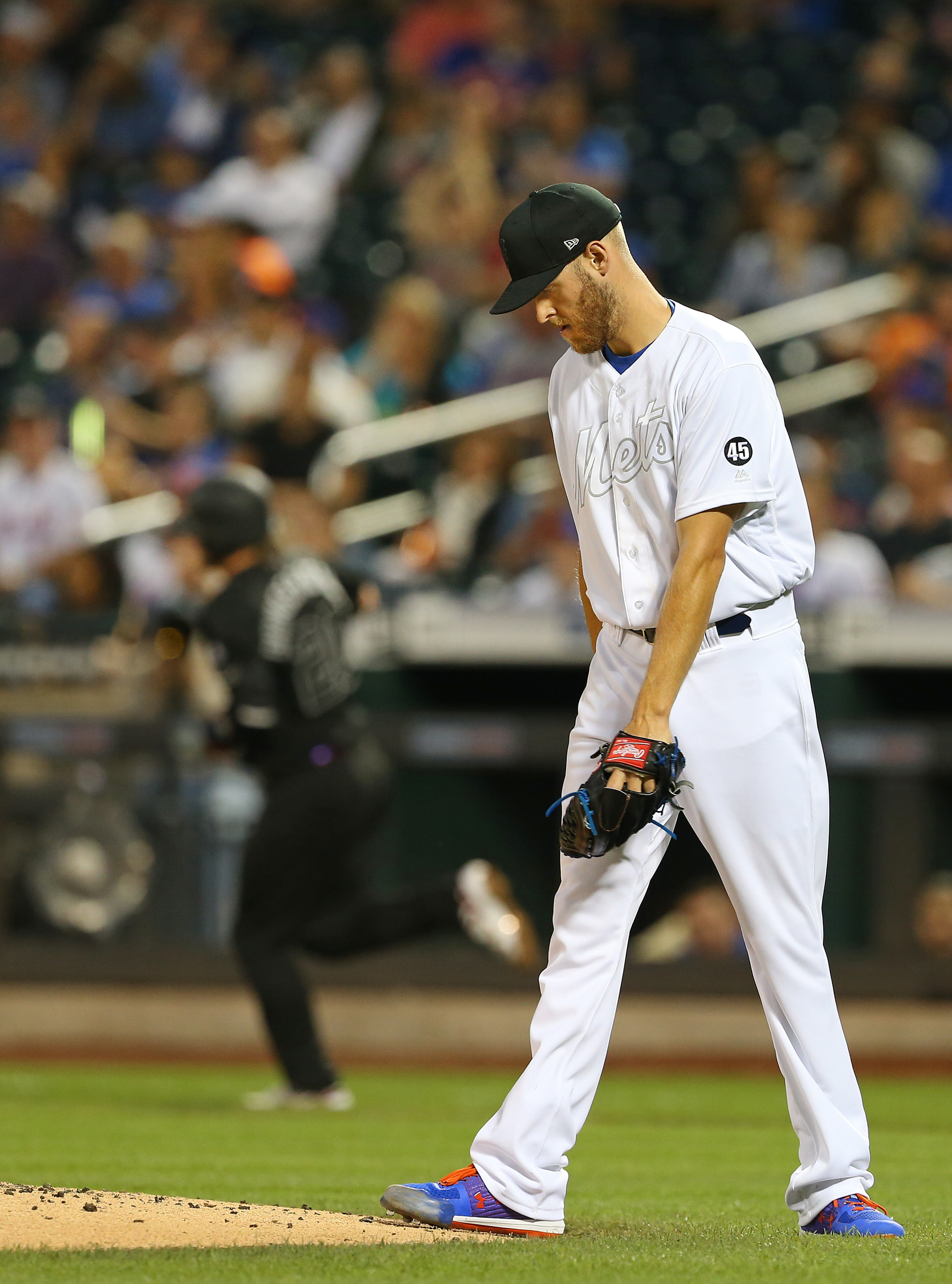 Pitcher Zack Wheeler #45 of the New York Mets reacts after conceding a home run to Josh Donaldson #20 of the Atlanta Braves during the third inning of a game at Citi Field on August 24, 2019 in New York City. Teams are wearing special color schemed uniforms with players choosing nicknames to display for Players' Weekend. (Photo by Rich Schultz/Getty Images)