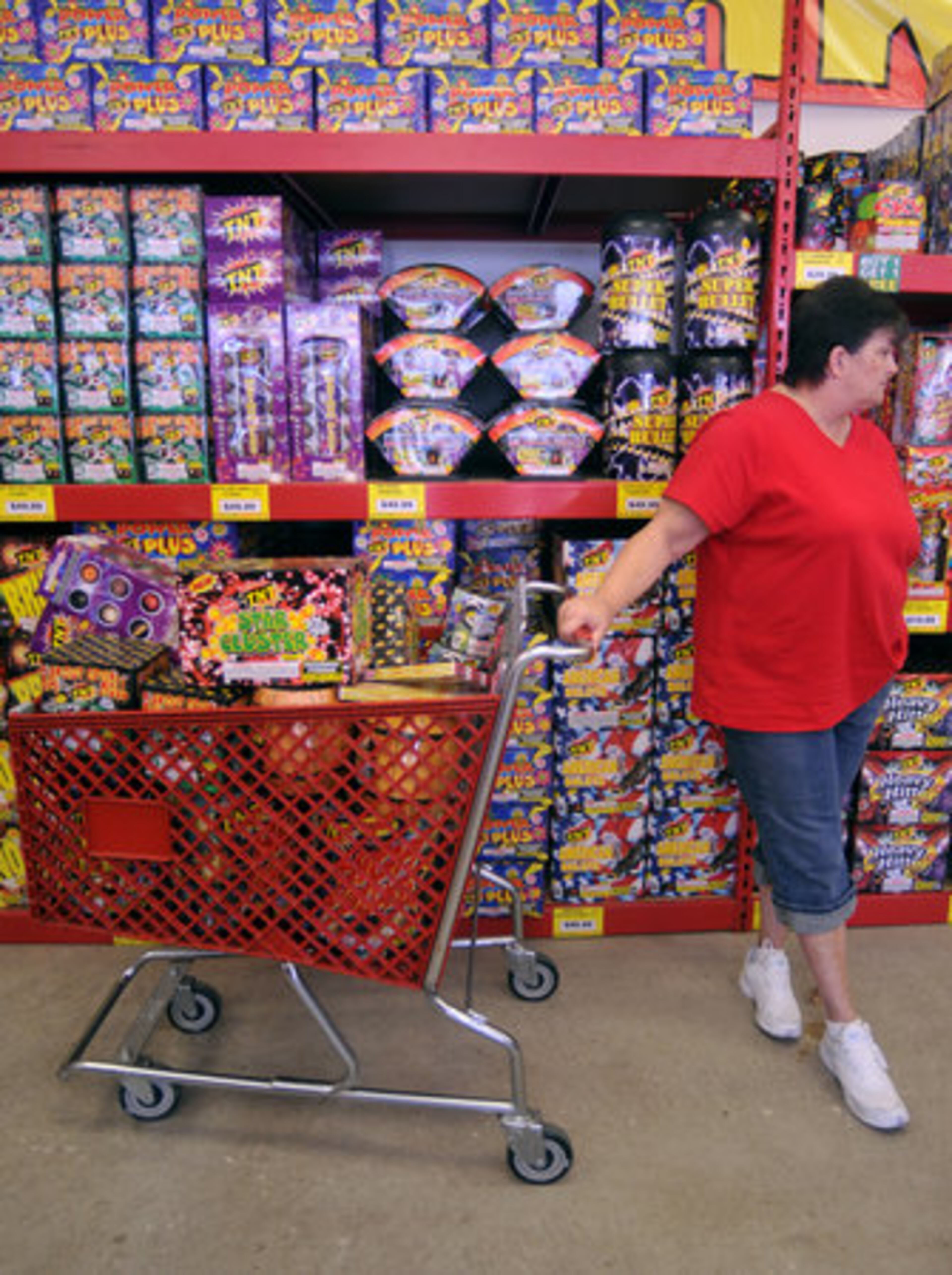 Judy Egelston of Middletown waits for her husband with their fireworks at TNT Fireworks. "He's like a kid in a candy store," she said, as he goes to get more fireworks before they check out.