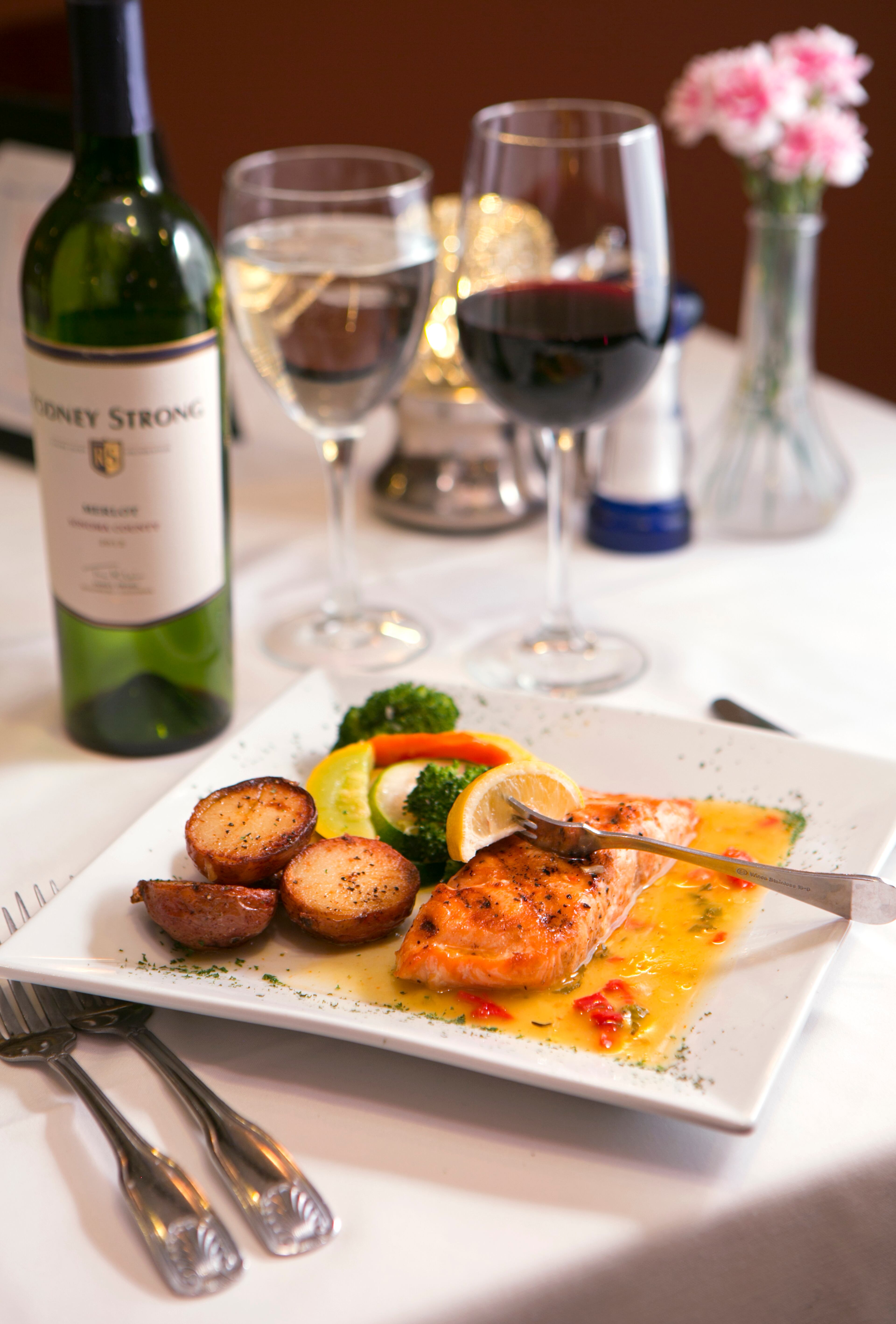 April 7, 2016 - Johns Creek, Ga: Gluten free grilled salmon is served with a glass of Rodney Strong Merlot at Altobeli's Restaurant and Piano Bar Thursday, April 7, 2016, in Johns Creek, Ga. Altobeli's Restaurant and Piano Bar is an Italian neighborhood restaurant that's served the community for over 25 years. This is for the insider's guide feature about the Newtown neighborhood. PHOTO / JASON GETZ