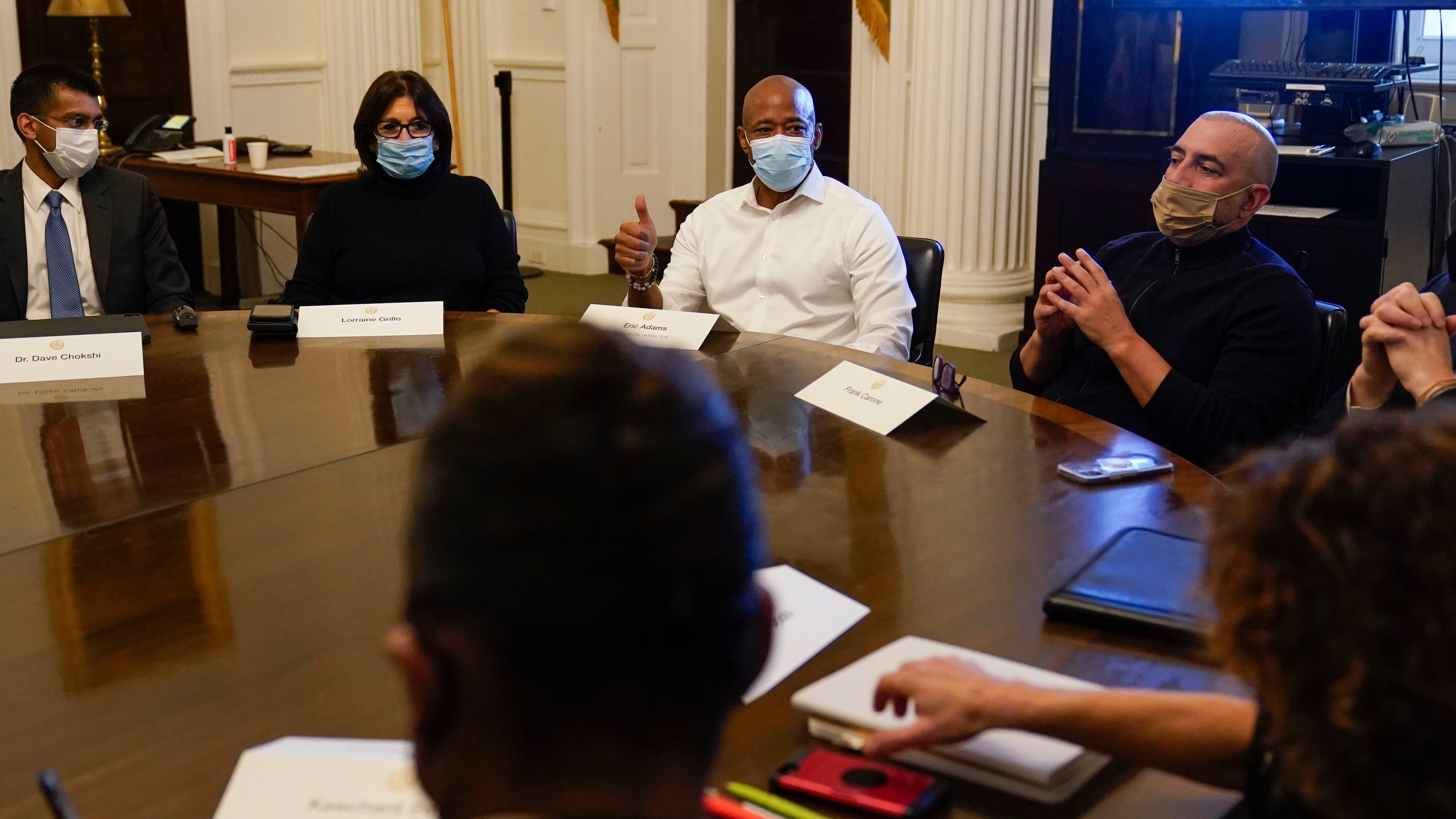 FILE - New York City Mayor Eric Adams, center, speaks during a cabinet meeting on his first day in office in New York, Jan. 1, 2022. To Adams' right is his Chief of Staff Frank Carone. (AP Photo/Seth Wenig, File)