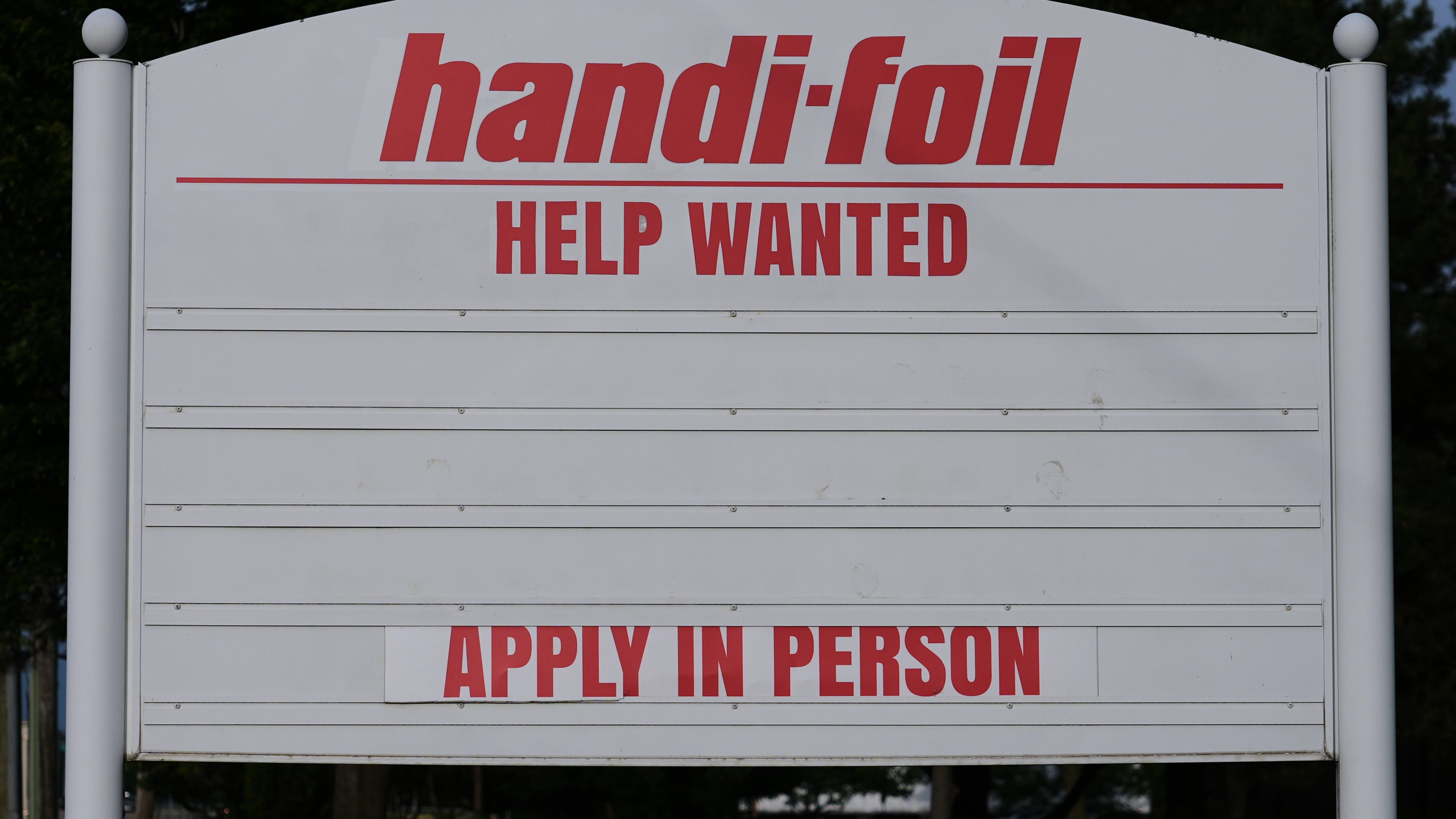 A help wanted sign is seen outside of a company in Wheeling, Ill., Monday, June 8, 2026. (AP Photo/Nam Y. Huh)