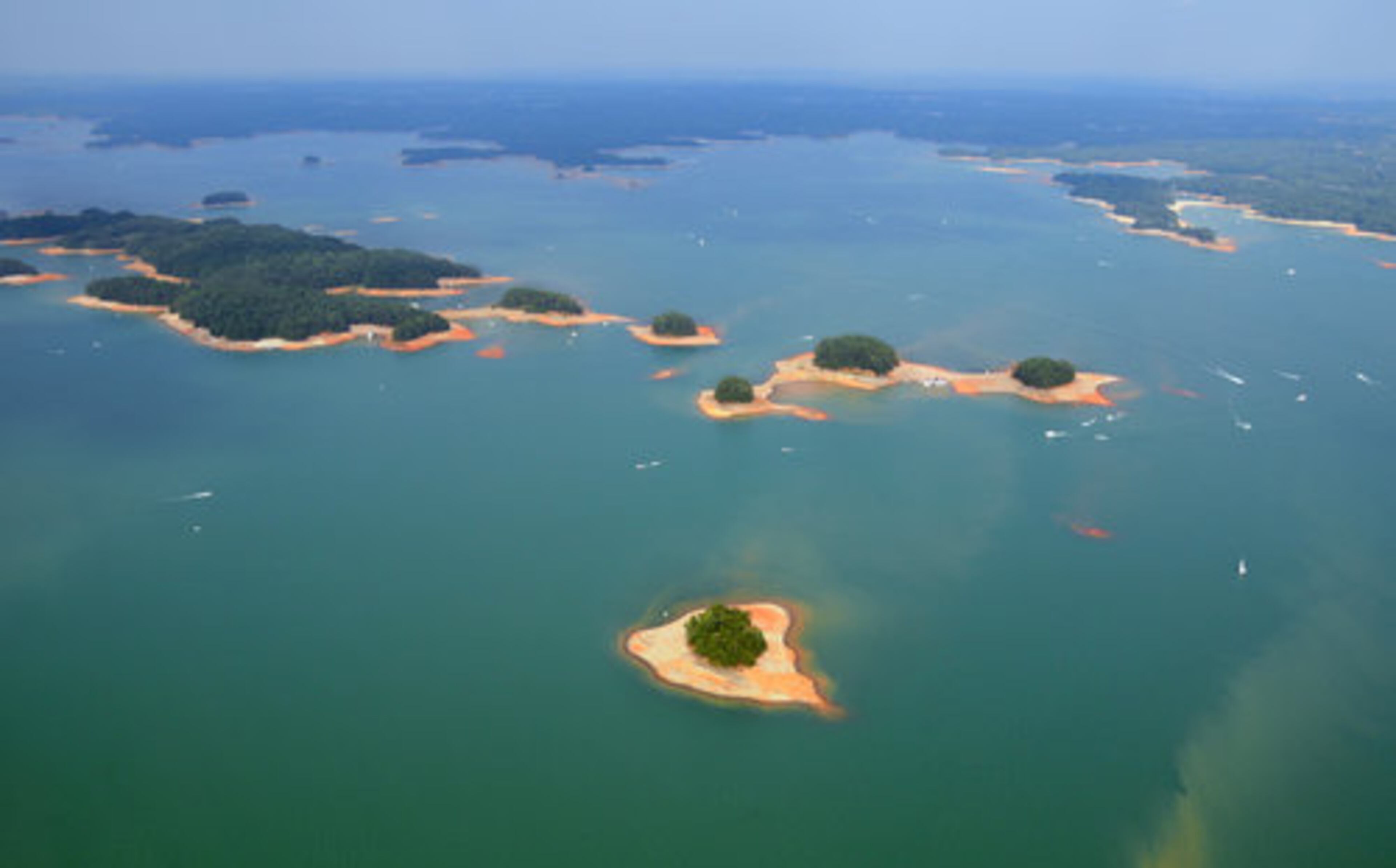 This group of islands in the middle of the lake, looking toward the east, is a benchmark of sorts - their shorelines steadily increase as the lake's level drops. The trio of tree-covered islands (center) are not connected during full pool and a very small island, visible by air, begins to reveal itself (center right).