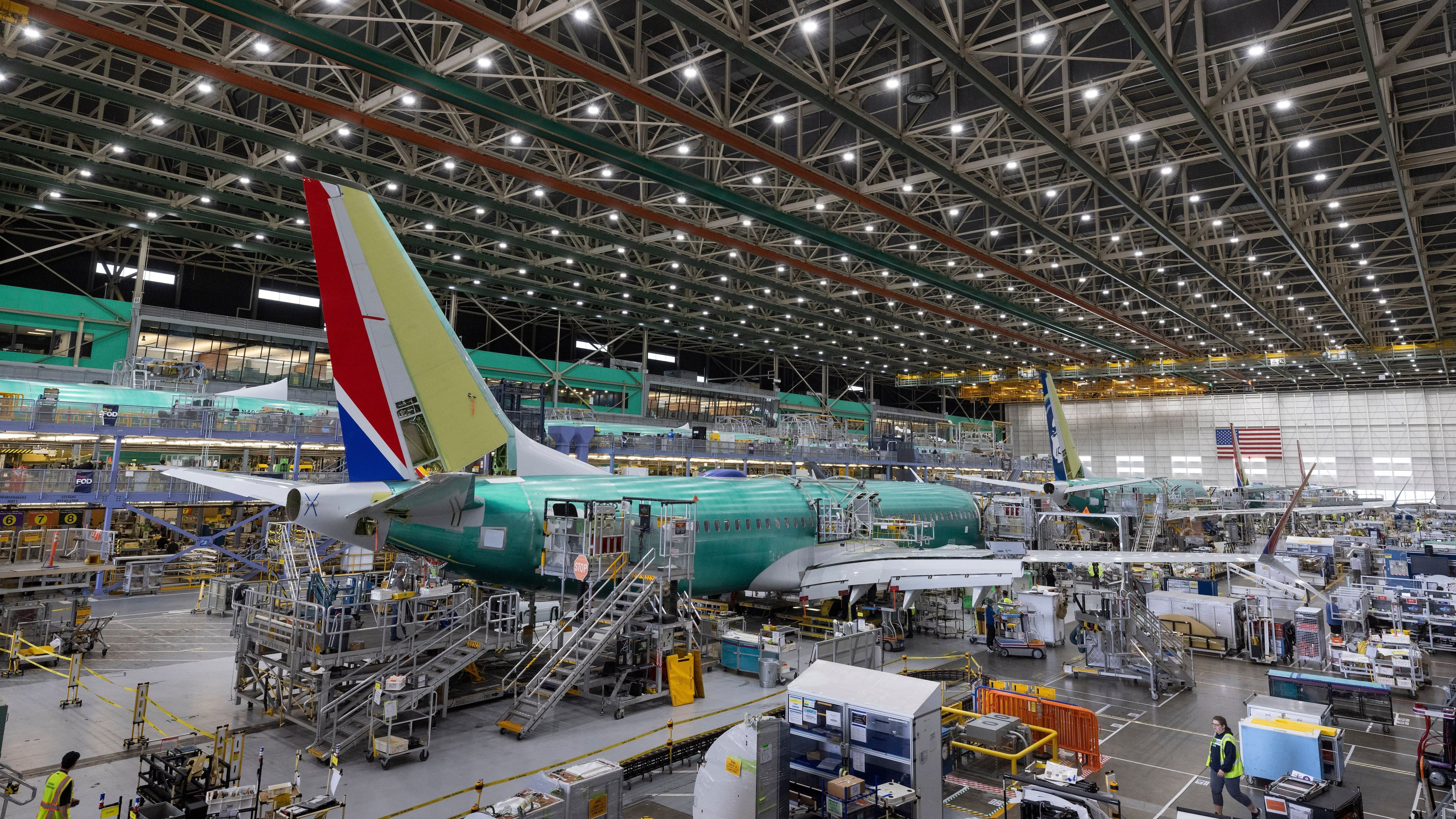 FILE - Boeing employees work on a 737 MAX airplane on the final assembly line at Boeing's plant in Renton, Wash., on June 15, 2022. (Ellen M. Banner/The Seattle Times via AP, Pool, File)