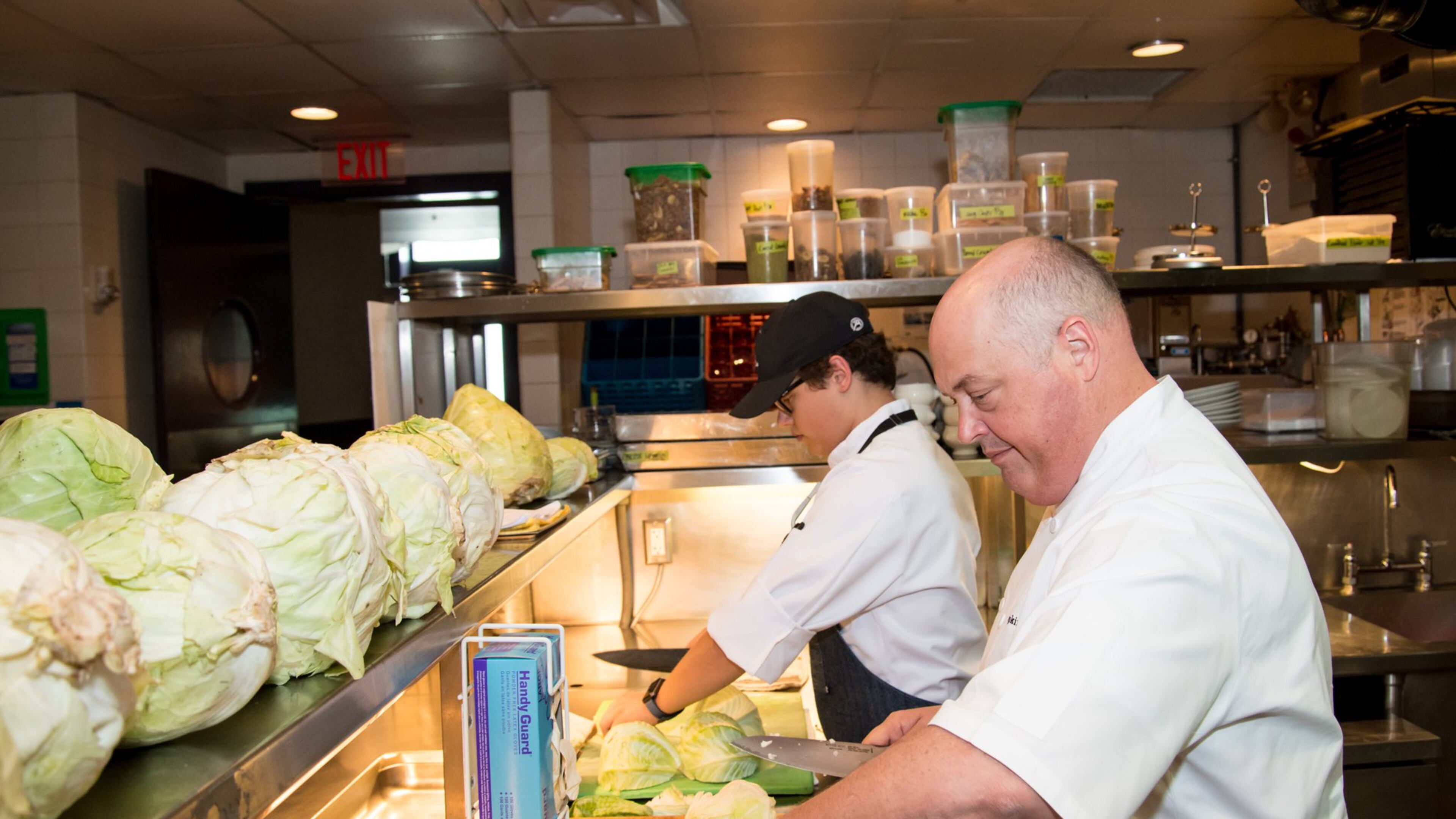 Chef Linton Hopkins and son Linton Hopkins Jr. chop cabbage for sauerkraut at Restaurant Eugene. CONTRIBUTED BY MIA YAKEL