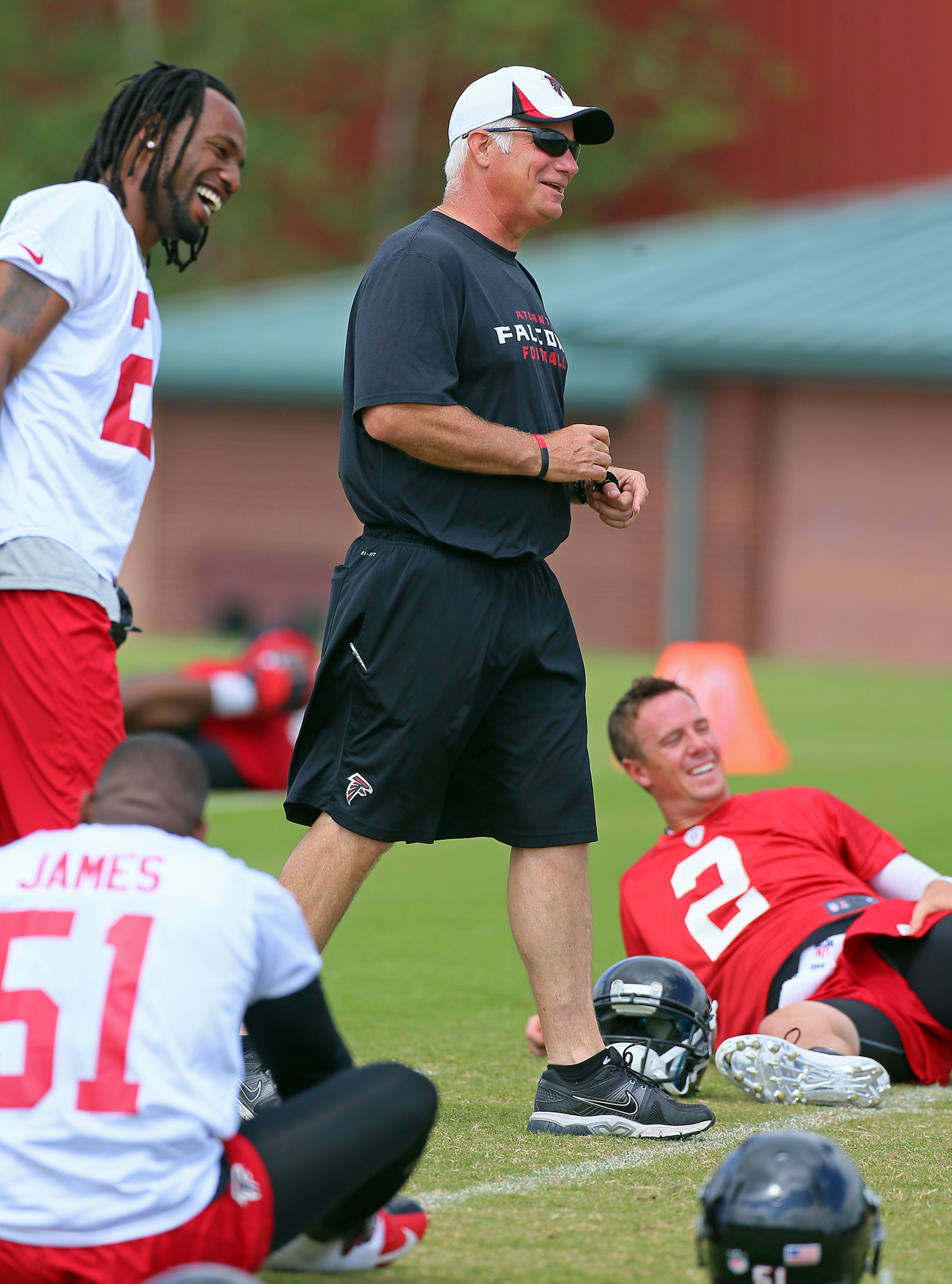 Falcons cornerback Asante Samuel (left) has head coach Mike Smith and quarterback Matt Ryan laughing as he jokes around during team warmups on Wednesday, May 29, 2013, in Flowery Branch. CURTIS COMPTON / CCOMPTON@AJC.COM