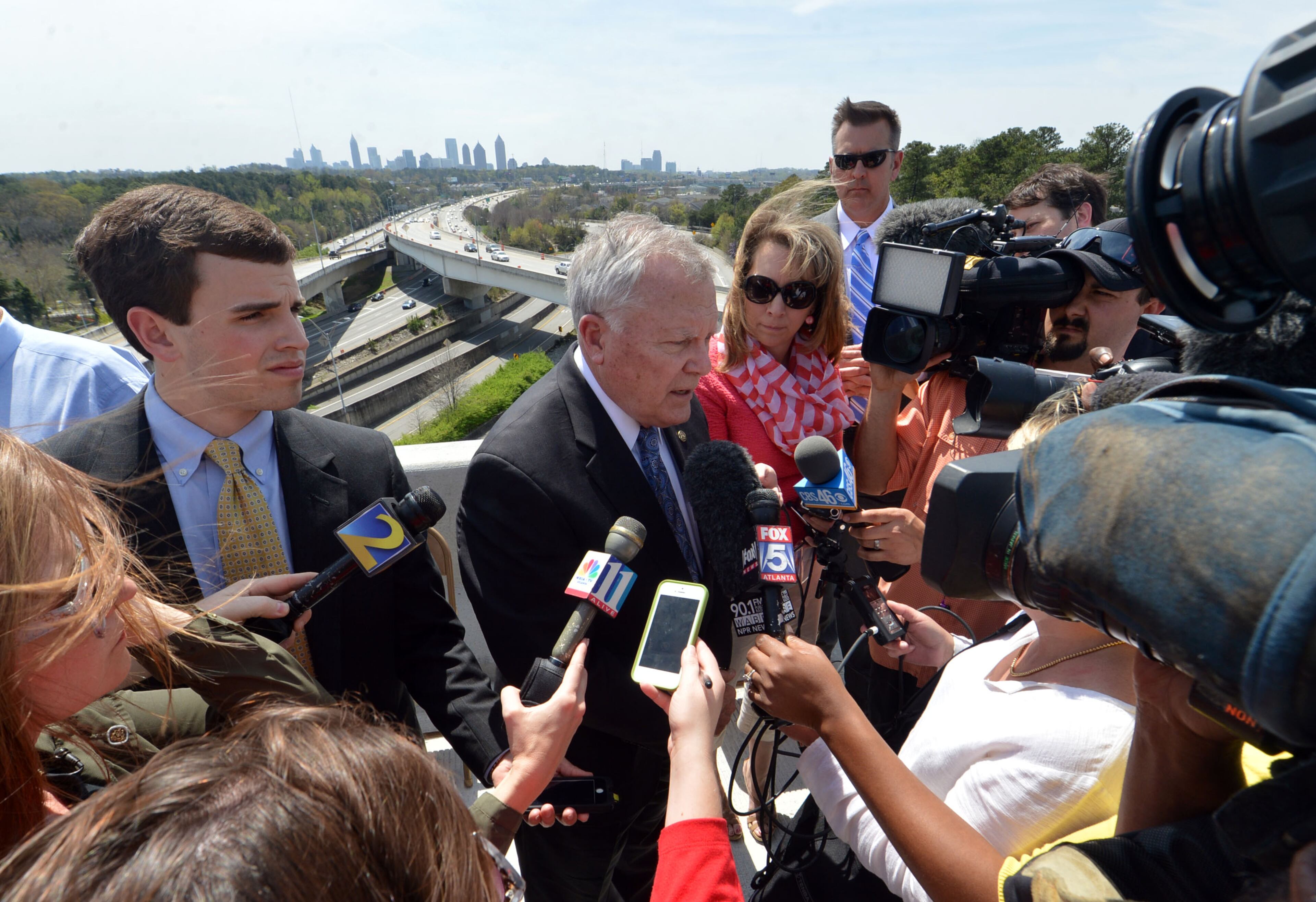 Governor Nathan Deal talks with the media following the program. Deal and other state and local leaders conducted a brief ribbon-cutting celebration of the opening of the new flyover ramps Wednesday, April 2, 2014. The ramps provide I-85 southbound traffic with direct access to GA 400 northbound and also give GA 400 southbound motorists a direct ramp to I-85 northbound.