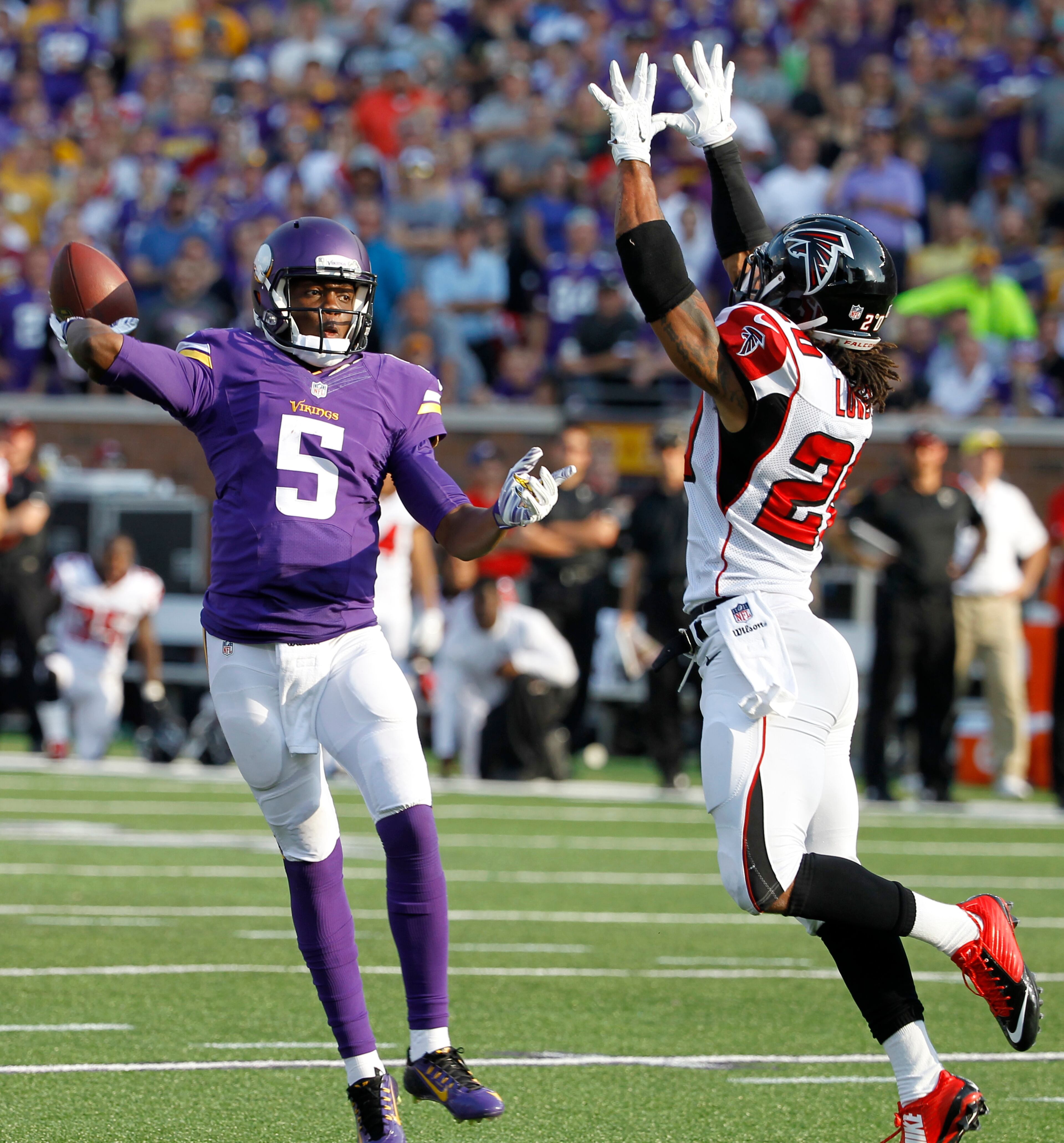 Minnesota Vikings quarterback Teddy Bridgewater (5) looks to pass over Atlanta Falcons free safety Dwight Lowery during the first half of an NFL football game, Sunday, Sept. 28, 2014, in Minneapolis. (AP Photo/Ann Heisenfelt)