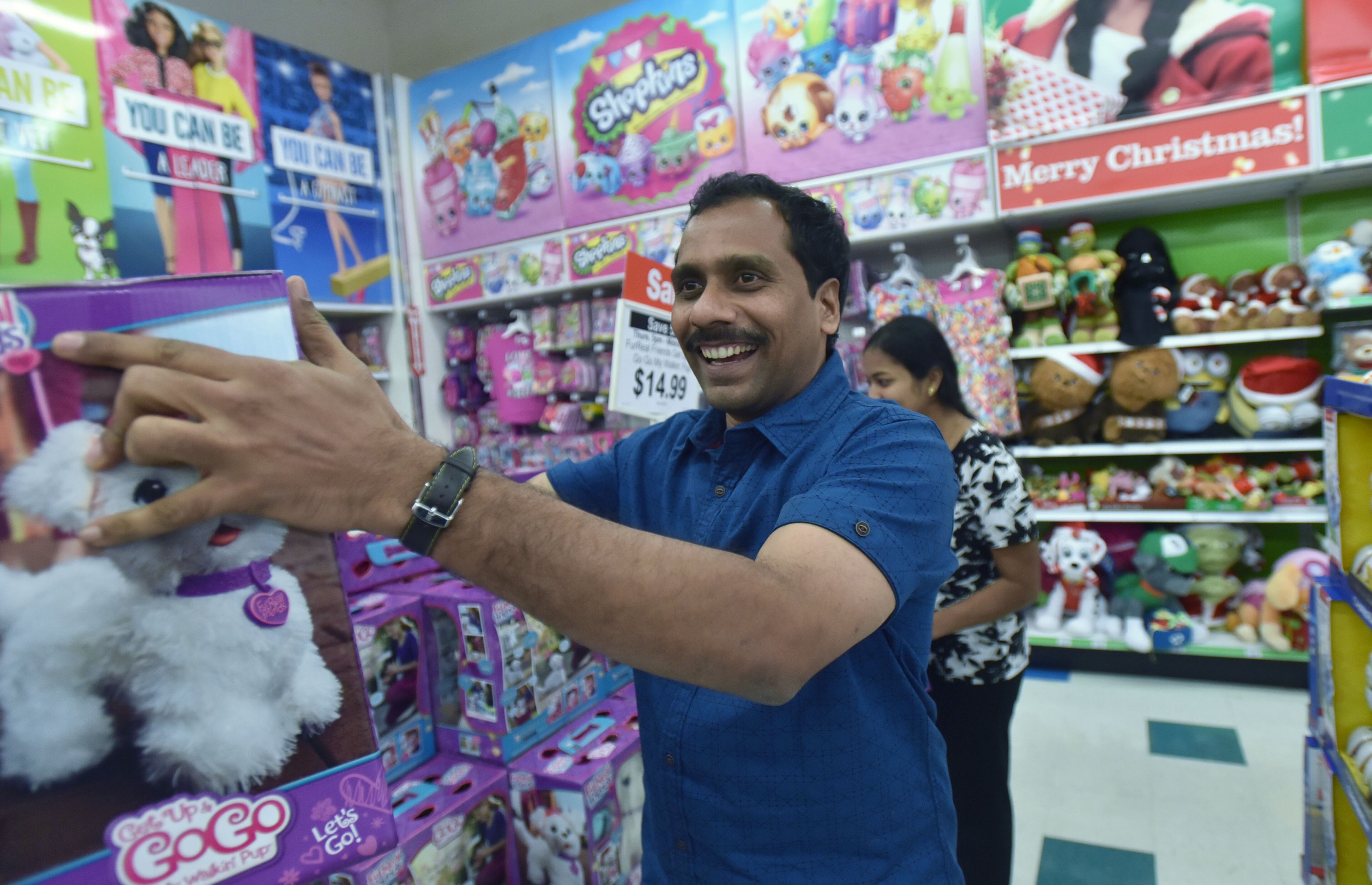 Ram Kamma picks up a puppy doll during the sale.