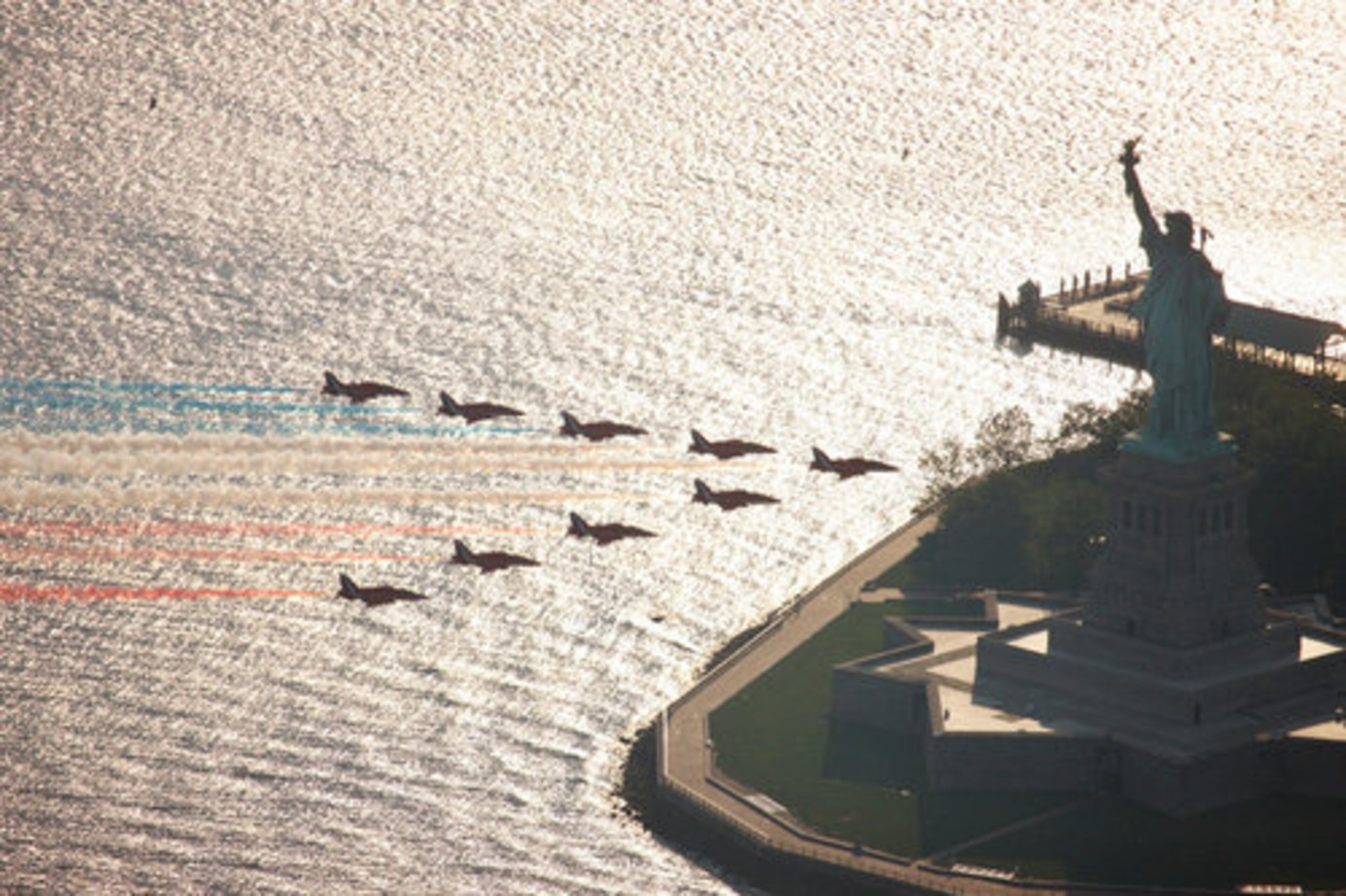 In this photo released by the British Royal Air Force, the British Royal Air Force "Red Arrows" aerobatic team performs a flyby over the Statue of Liberty in New York Harbor on Wednesday. The flyby was part of an air show during the team's first visit to New York City.