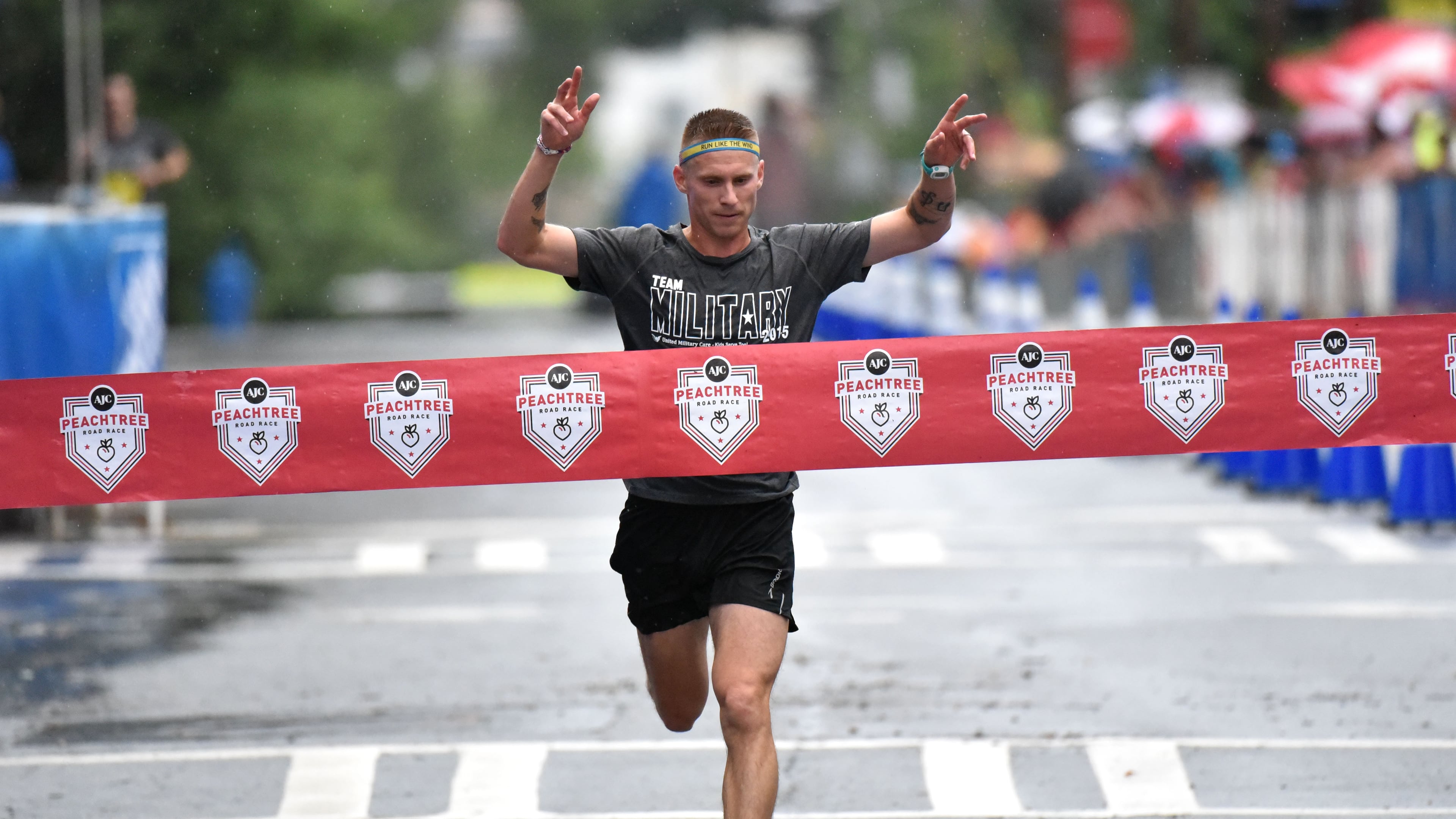 David Seymour with Team Army wins Kilometer Kids Charity Chase during the AJC Peachtree Road Race on Saturday, July 4, 2015. Kilometer Kids Charity Chase will feature six teams: Team Air Force, Team Army, Team Coast Guard, Team Marine Corps, Team National Guard and Team Navy. HYOSUB SHIN / HSHIN@AJC.COM