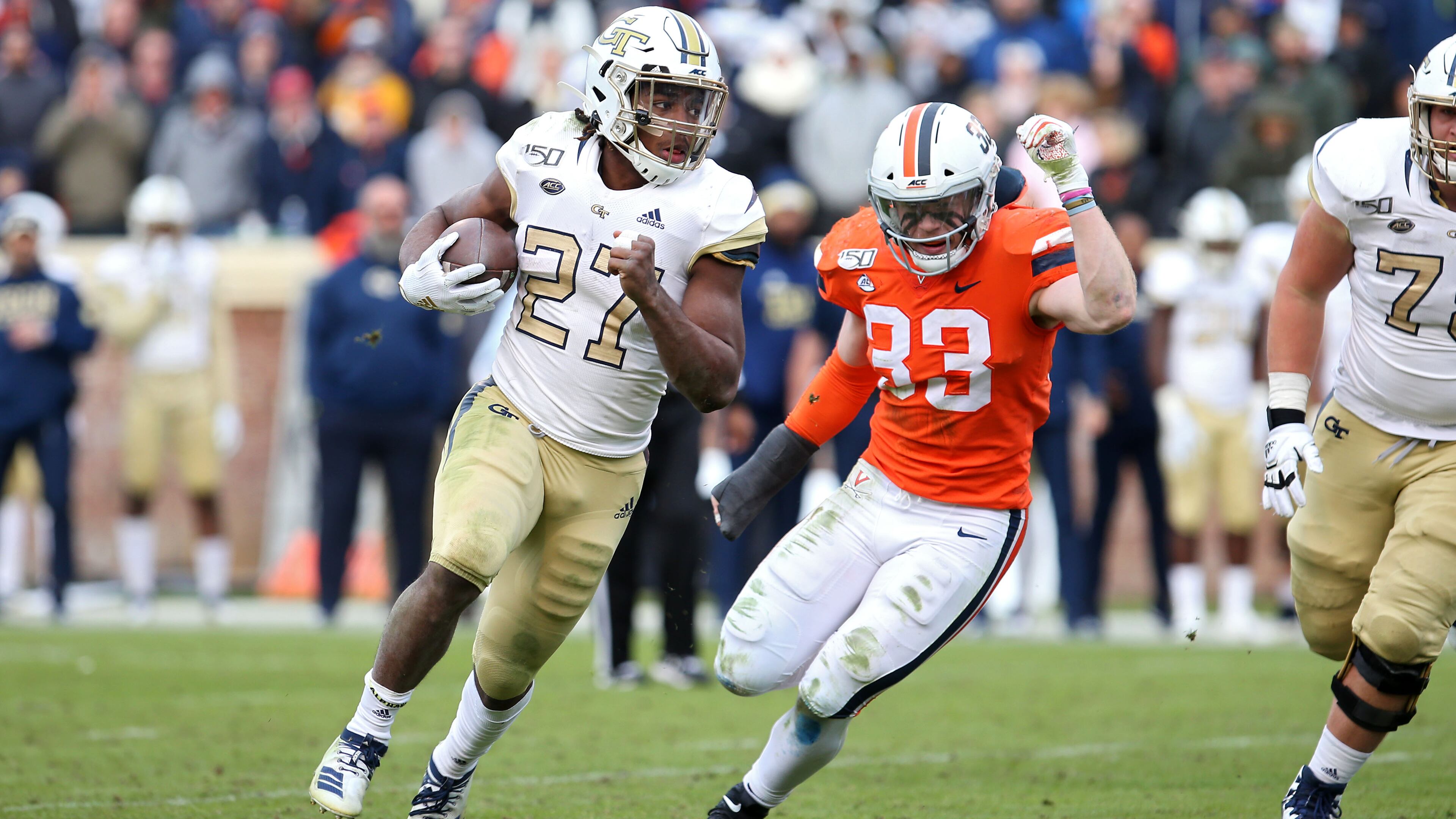 Jordan Mason #27 of the Georgia Tech Yellow Jackets rushes past Zane Zandier #33 of the Virginia Cavaliers in the second half during a game at Scott Stadium on November 9, 2019 in Charlottesville, Virginia. (Photo by Ryan M. Kelly/Getty Images)