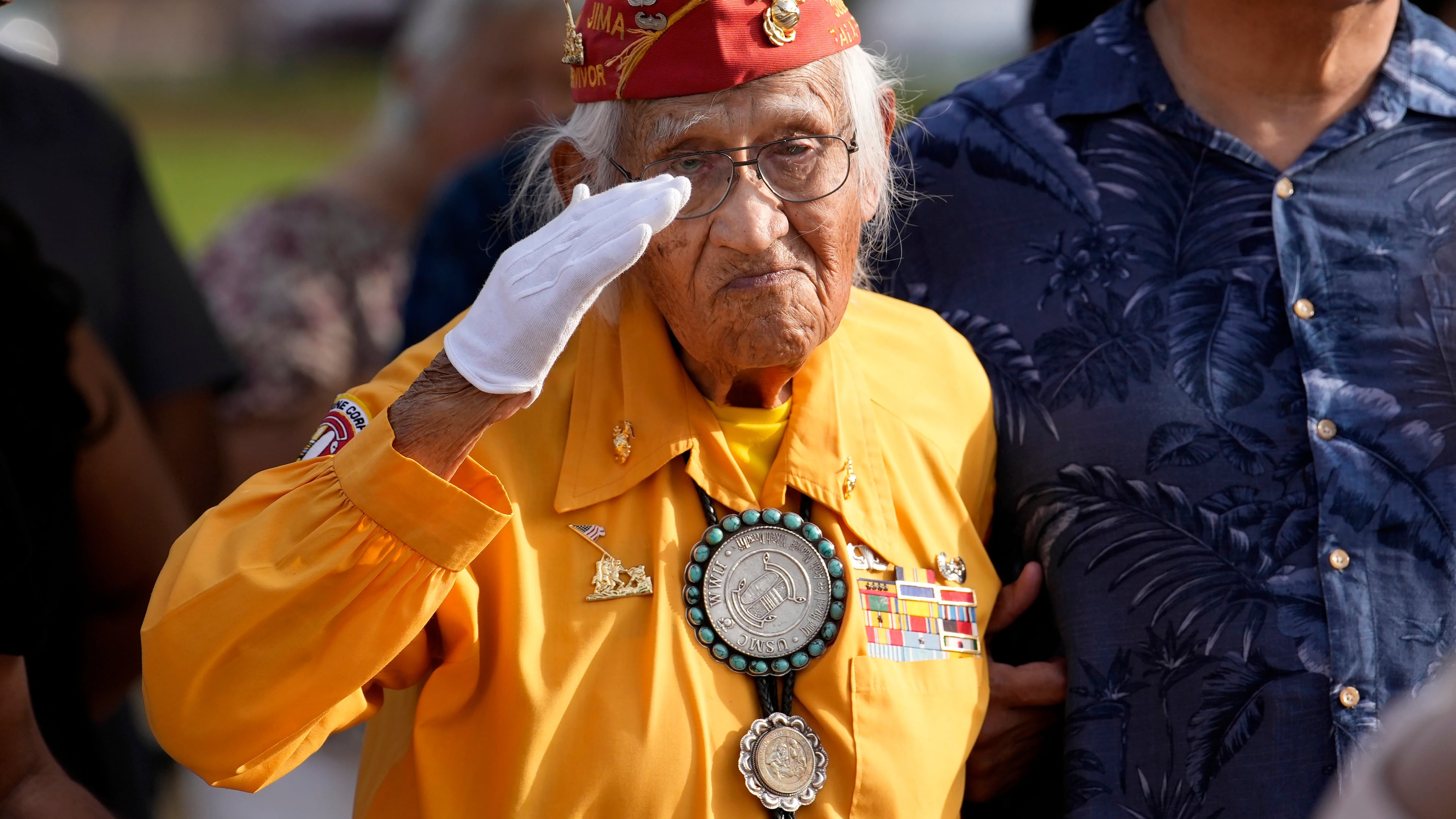 Navajo Code Talker Thomas Begay salutes during the national anthem during a ceremony on Navajo Code Talkers Day, Friday, Aug. 14, 2026, in Phoenix. (AP Photo/Ross D. Franklin)
