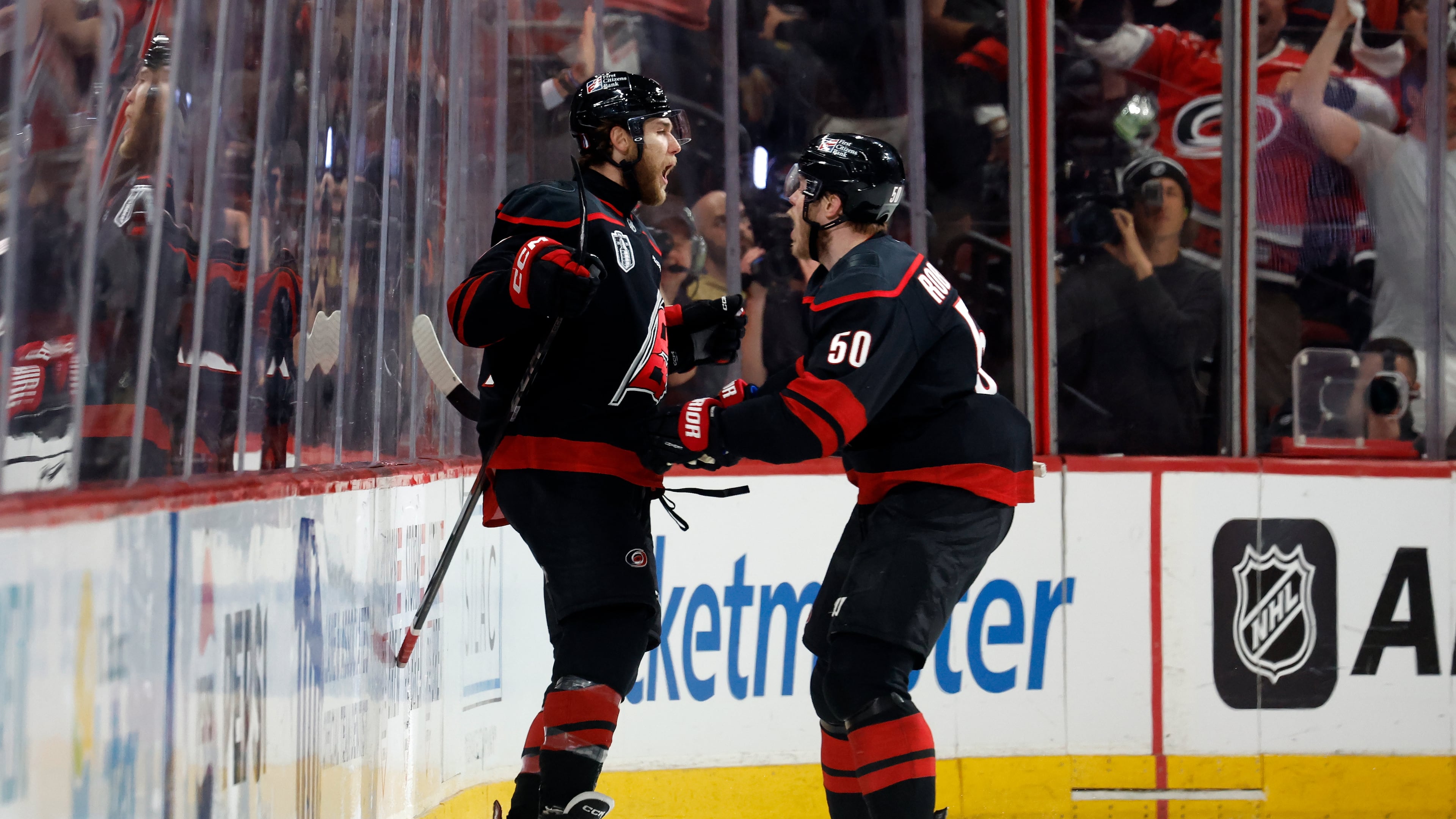 Carolina Hurricanes' Mark Jankowski, left, celebrates after his goal with Eric Robinson (50) during the third period in Game 2 of the NHL hockey Stanley Cup Final series against the Vegas Golden Knights in Raleigh, N.C., Thursday, June 4, 2026. (AP Photo/Karl DeBlaker)