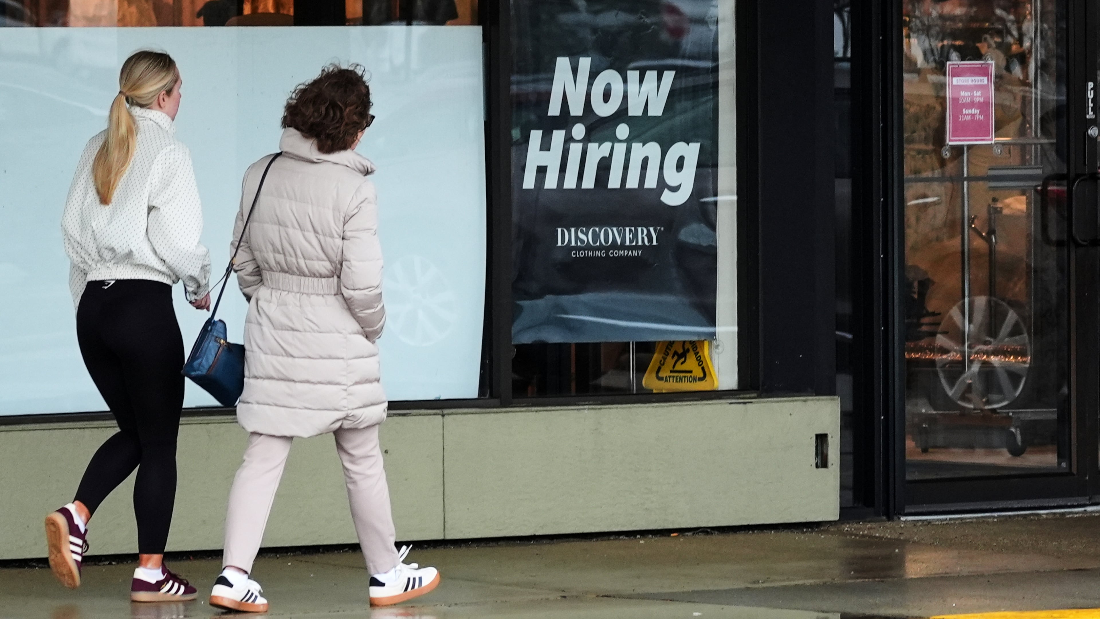 Now hiring sign is displayed at a retail store, in Arlington Heights, Ill., Thursday, April 2, 2026. (AP Photo/Nam Y. Huh)