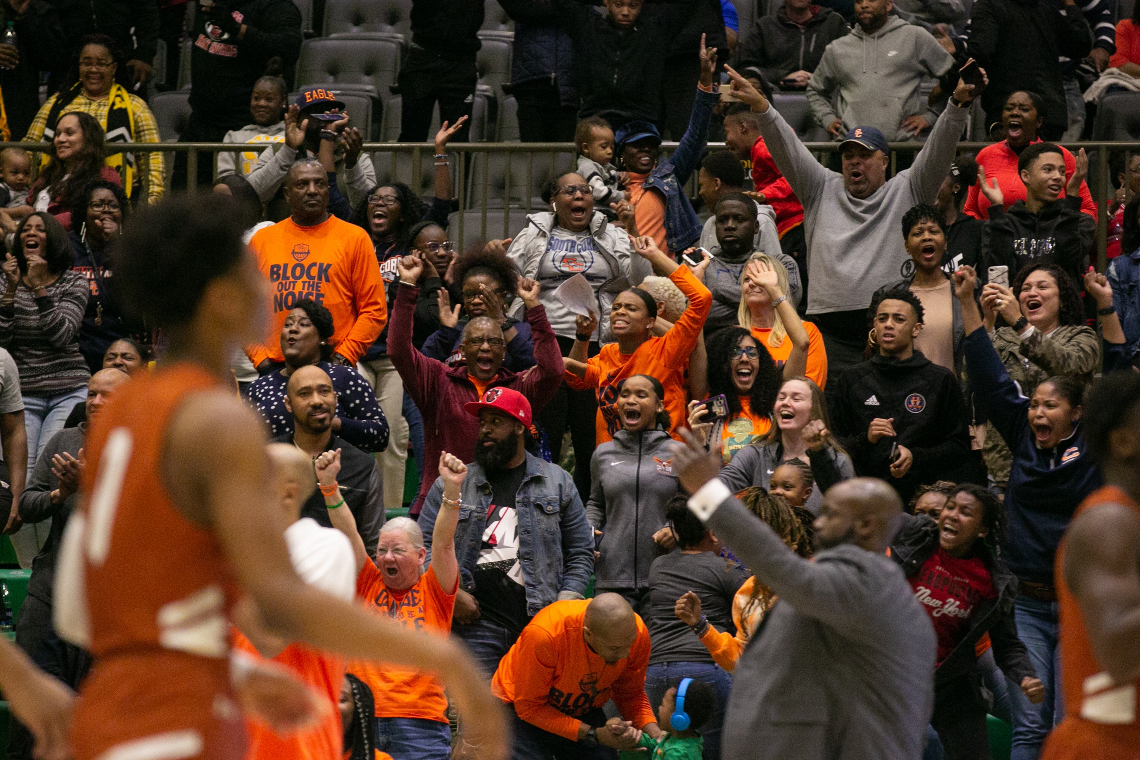 South Cobb supporters celebrate after a shot tied the score and took the game into overtime during a GHSA basketball game between Lanier and South Cobb at Buford City Arena in Buford, Georgia, on Friday, February 28, 2020. Lanier won 63-57. (Photo/Rebecca Wright for the AJC)