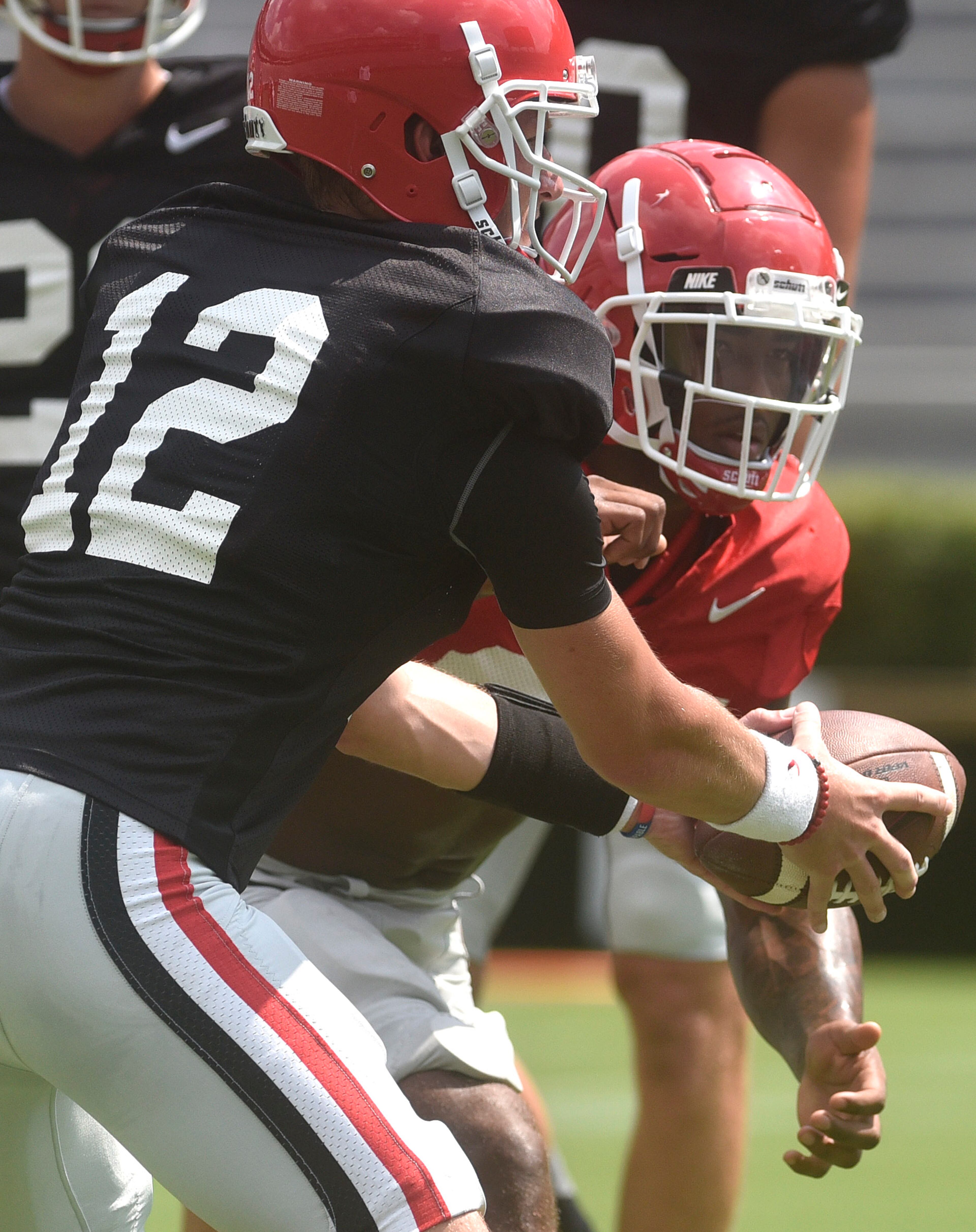 Georgia quarterback Brice Ramsey, 12, hands off to Georgia running back Brian Herrien (35) during an open practice during the annual UGA Fan Day at Sanford Stadium on Saturday, Aug 5, 2017 in Athens, Ga.
(RICHARD HAMM)