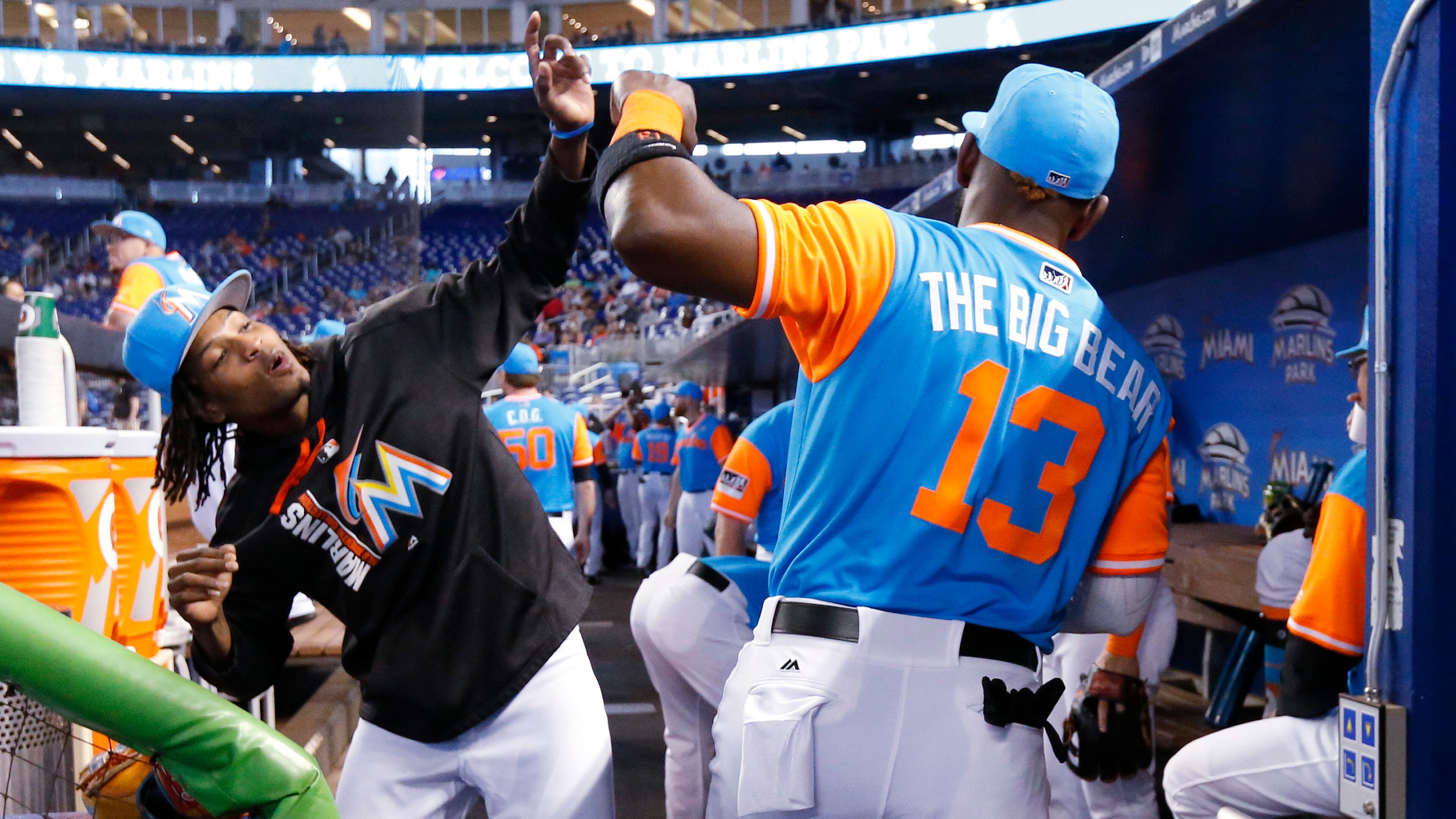 Miami Marlins' Marcell Ozuna (13) and Jose Urena go through their pregame routine before the start of a baseball game against the San Diego Padres, Sunday, Aug. 27, 2017, in Miami. The Marlins defeated the Padres 6-2. (AP Photo/Wilfredo Lee)