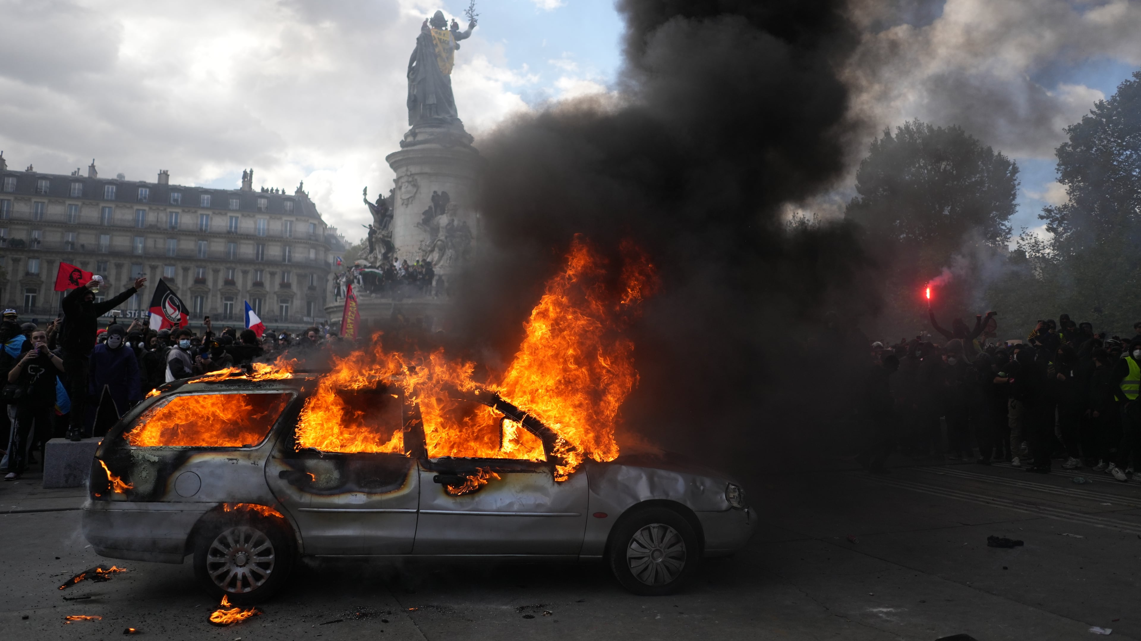 A car burns at Republique square during a protest against rising living costs, joining students' grievances, in Paris, Saturday, Oct. 17, 2026. (AP Photo/Thibault Camus)