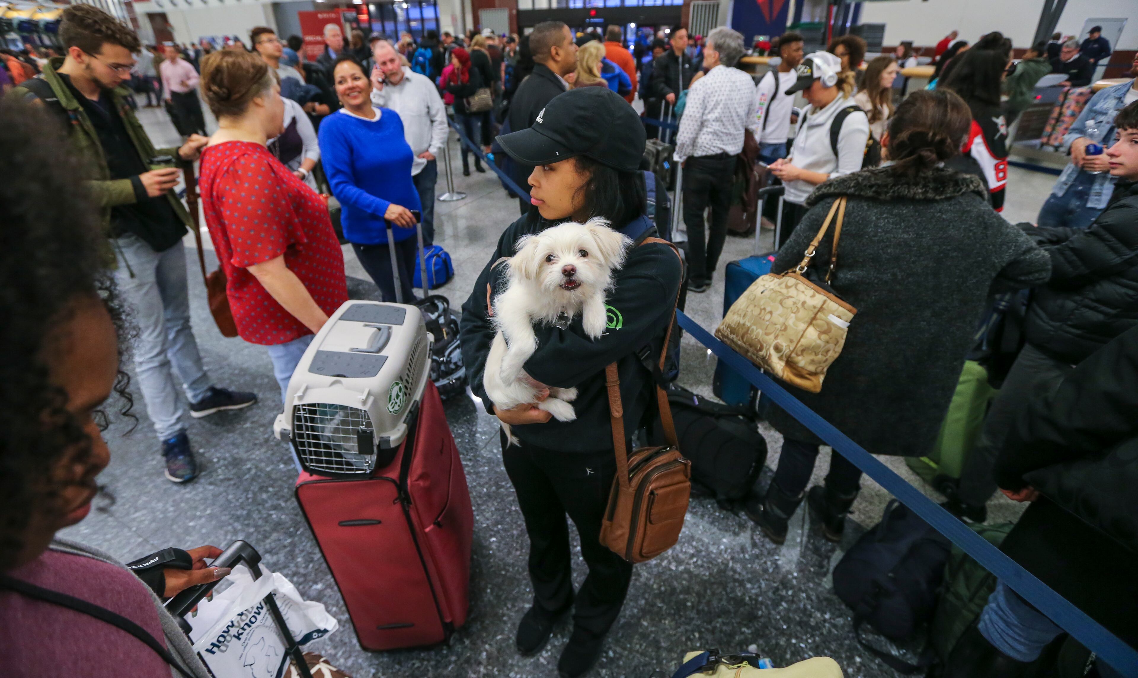 December 16, 2017 Hartsfield-Jackson International Airport: Destiny Easley and Bronx from Jacksonville, Alabama on her way to Buckeye, Arizona had to miss her flight because of the long lines at the Delta ticket counter on Monday Dec. 18, 2017 at Hartsfield-Jackson International Airport the day after a massive power outage brought operations to halt. Power was restored at the worlds busiest airport after a massive outage Sunday afternoon that left planes and passengers stranded for hours, forced airlines to cancel more than 1,100 flights and created a logistical nightmare during the already-busy holiday travel season. Frustration remained high Monday at Hartsfield-Jackson International Airport as passengers tried to figure out if they could get to their next destinations. As of 7 a.m. Monday, 405 flights have been canceled. UPS and FedEx say the fire that knocked out power and shut down the worlds busiest airport wont delay holiday package deliveries. JOHN SPINK/JSPINK@AJC.COM