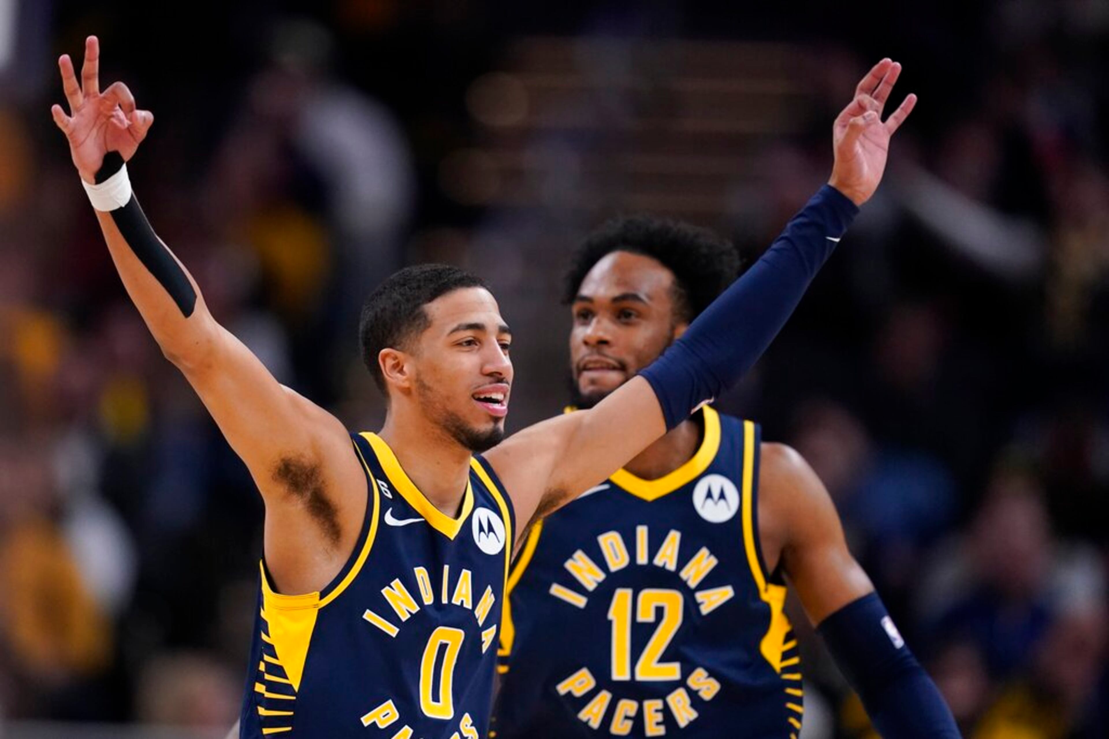 Indiana Pacers' Tyrese Haliburton (0) reacts after a 3-point basket by Buddy Hield during the second half of the team's NBA basketball game against the Atlanta Hawks, Tuesday, Dec. 27, 2022, in Indianapolis. (AP Photo/Darron Cummings)