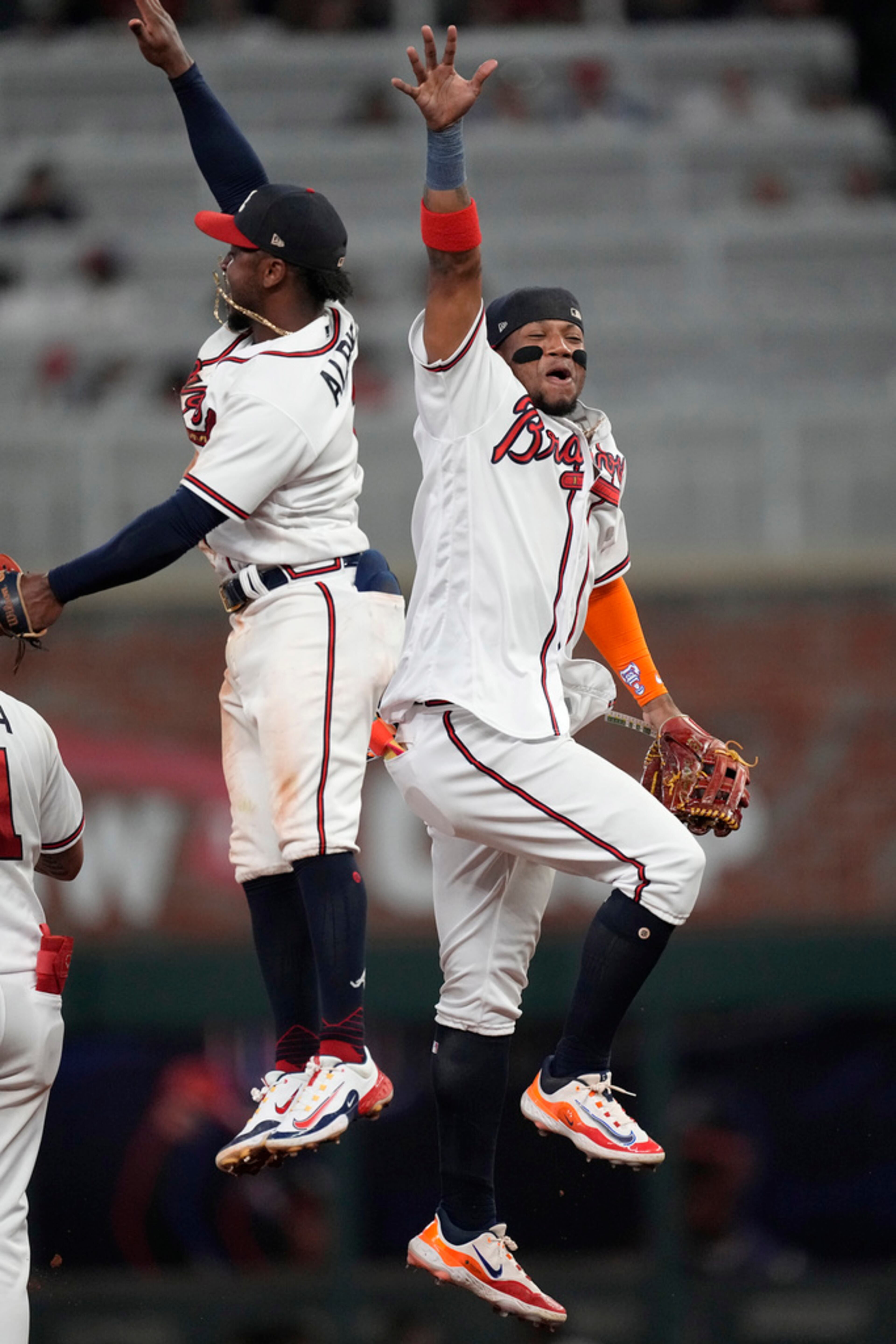 Atlanta Braves' Ozzie Albies, left, and Ronald Acuna Jr. celebrate the team's win over the Minnesota Twins in a baseball game Tuesday, June 27, 2023, in Atlanta. (AP Photo/John Bazemore)