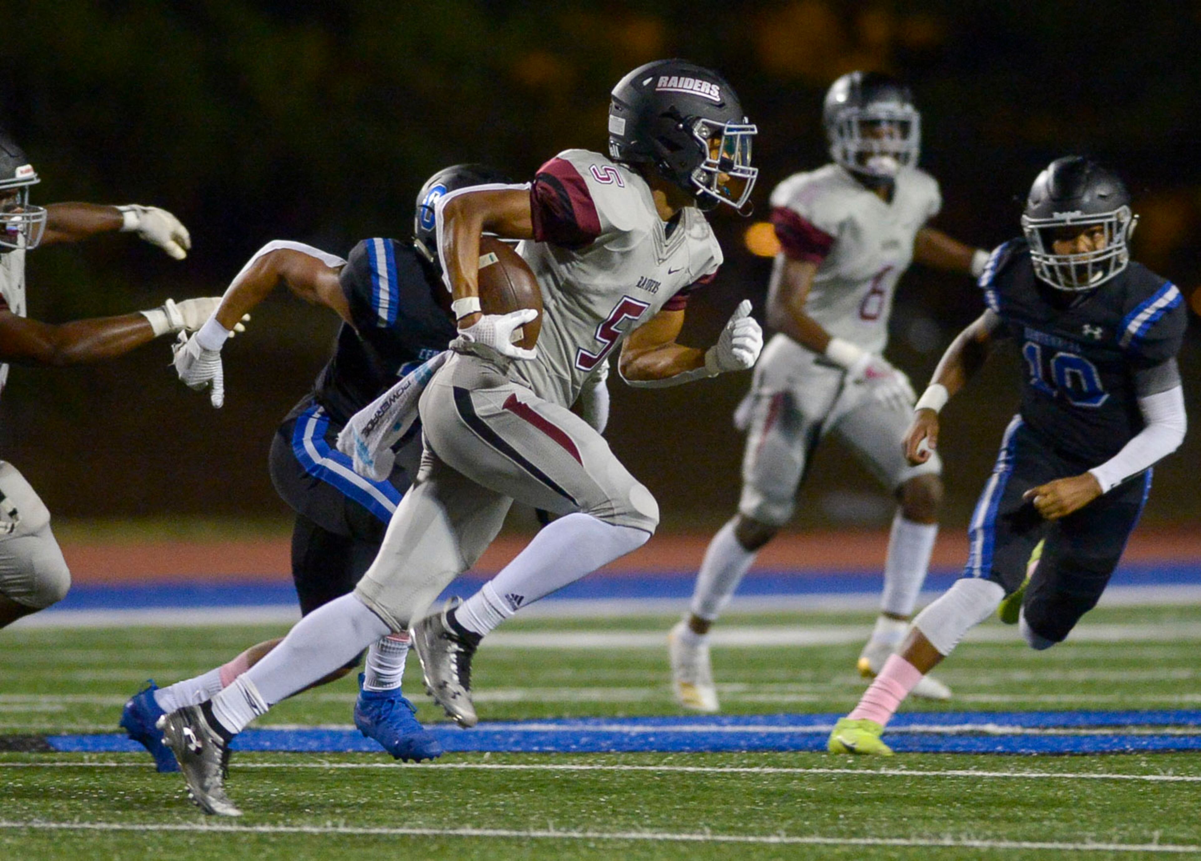 Alpharetta's Jaden Slocum (5) intercepts a pass and runs for yardage in the first half of Friday's game at Centennial. (Daniel Varnado/Special)