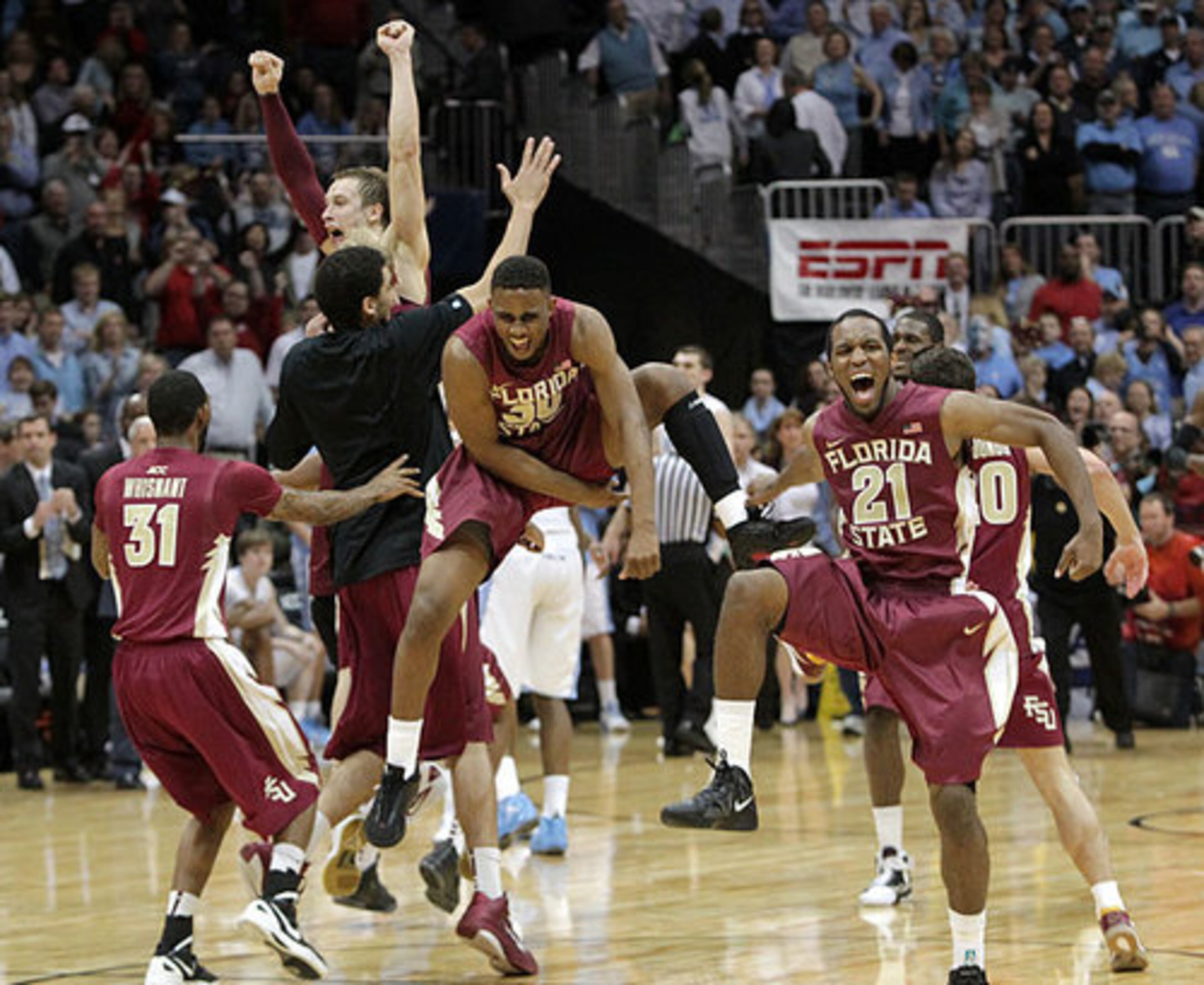Florida State Seminoles MVP Michael Snaer (21), Ian Miller (30-center) and the rest of the Seminoles celebrate winning the ACC Championship 85-82 over the North Carolina Tar Heels, Philips Arena, Sunday, March 11, 2012.