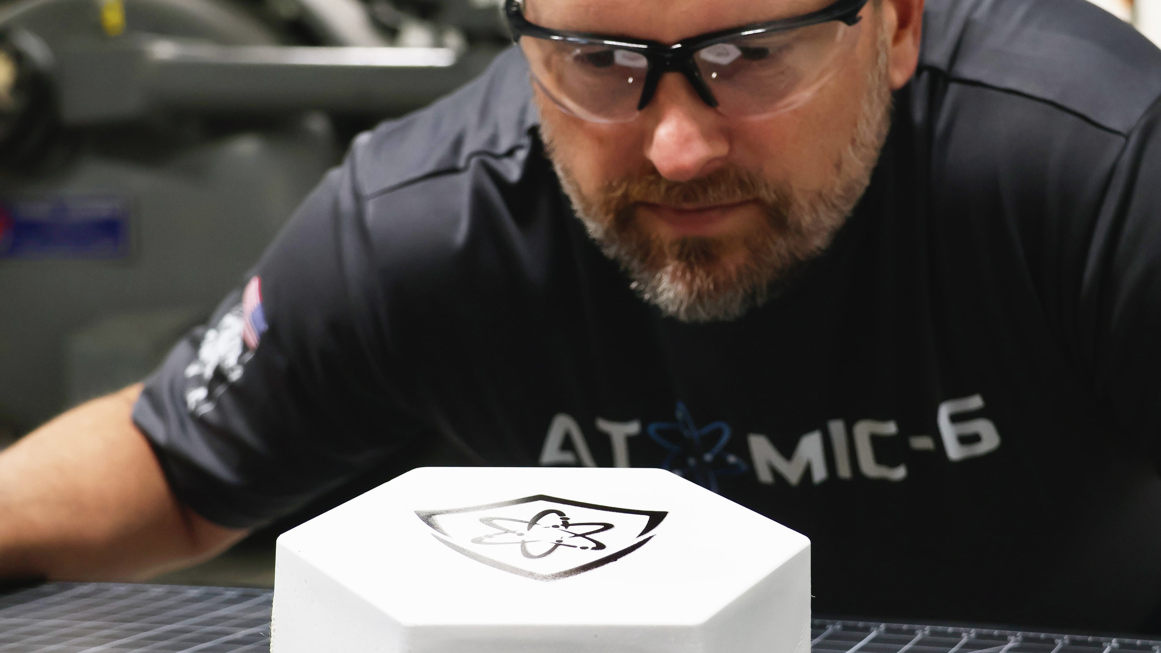 An inspector examines an Atomic-6 Space Armor tile, which is lighter than what is used today. (Courtesy of Atomic-6)