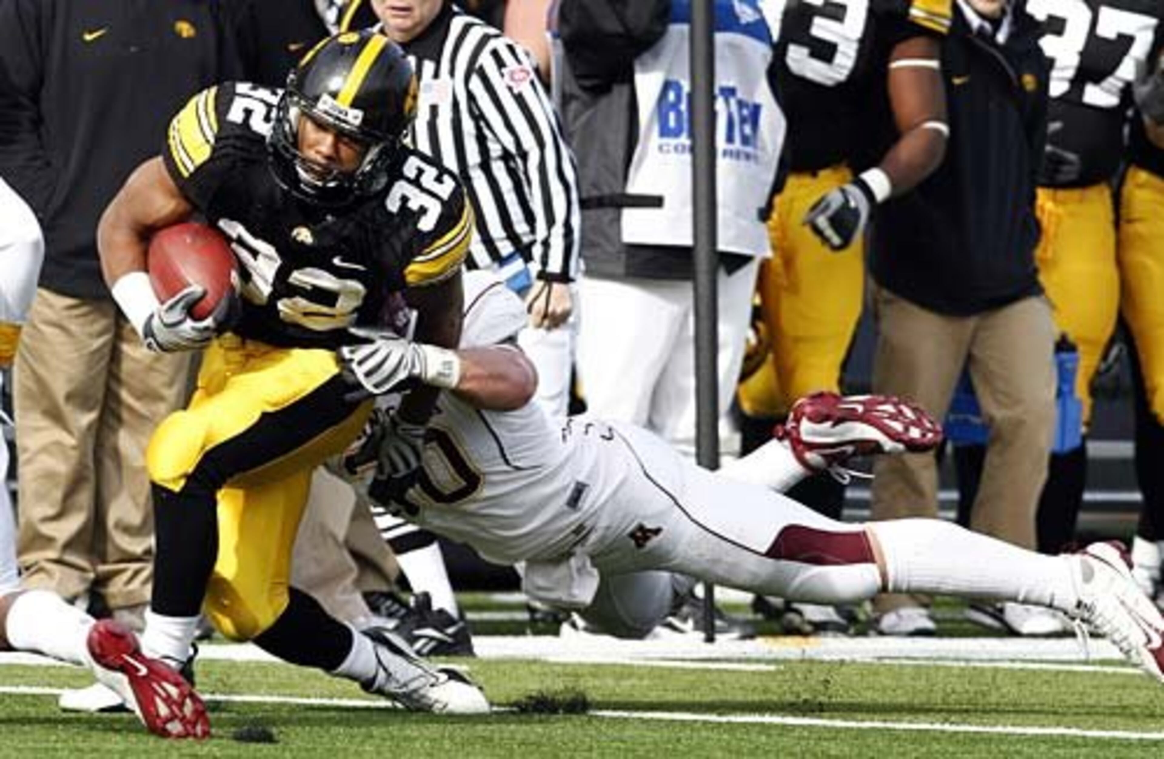 ADAM ROBINSON (32, left) averages 77.5 ypg for the Hawkeyes.