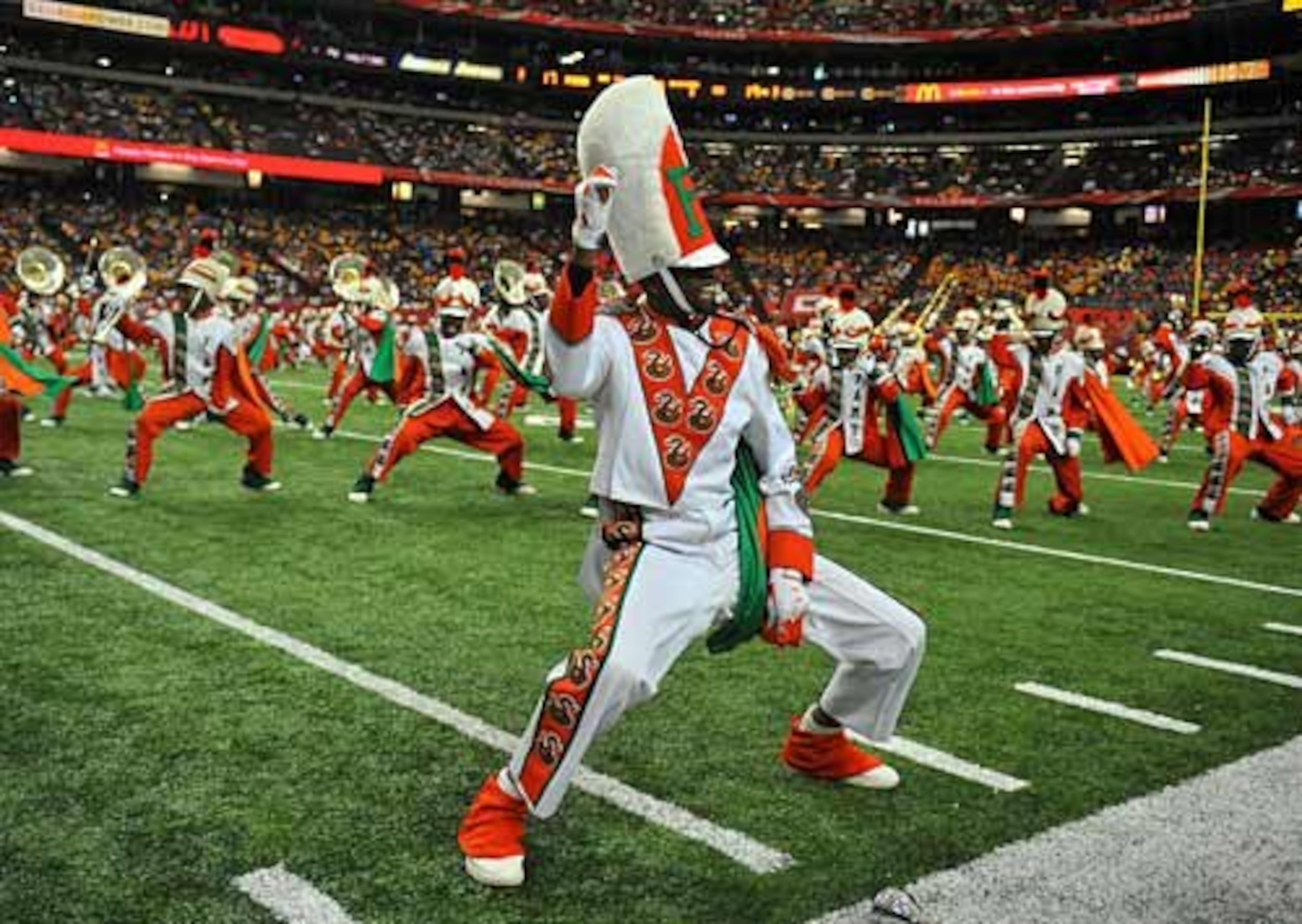 Jonathan Boise, one of five drum majors for the Florida A&M marching band, performs at halftime. The "Battle of the Bands" halftime show at the Classic has become a tradition that keeps fans in their seats.
