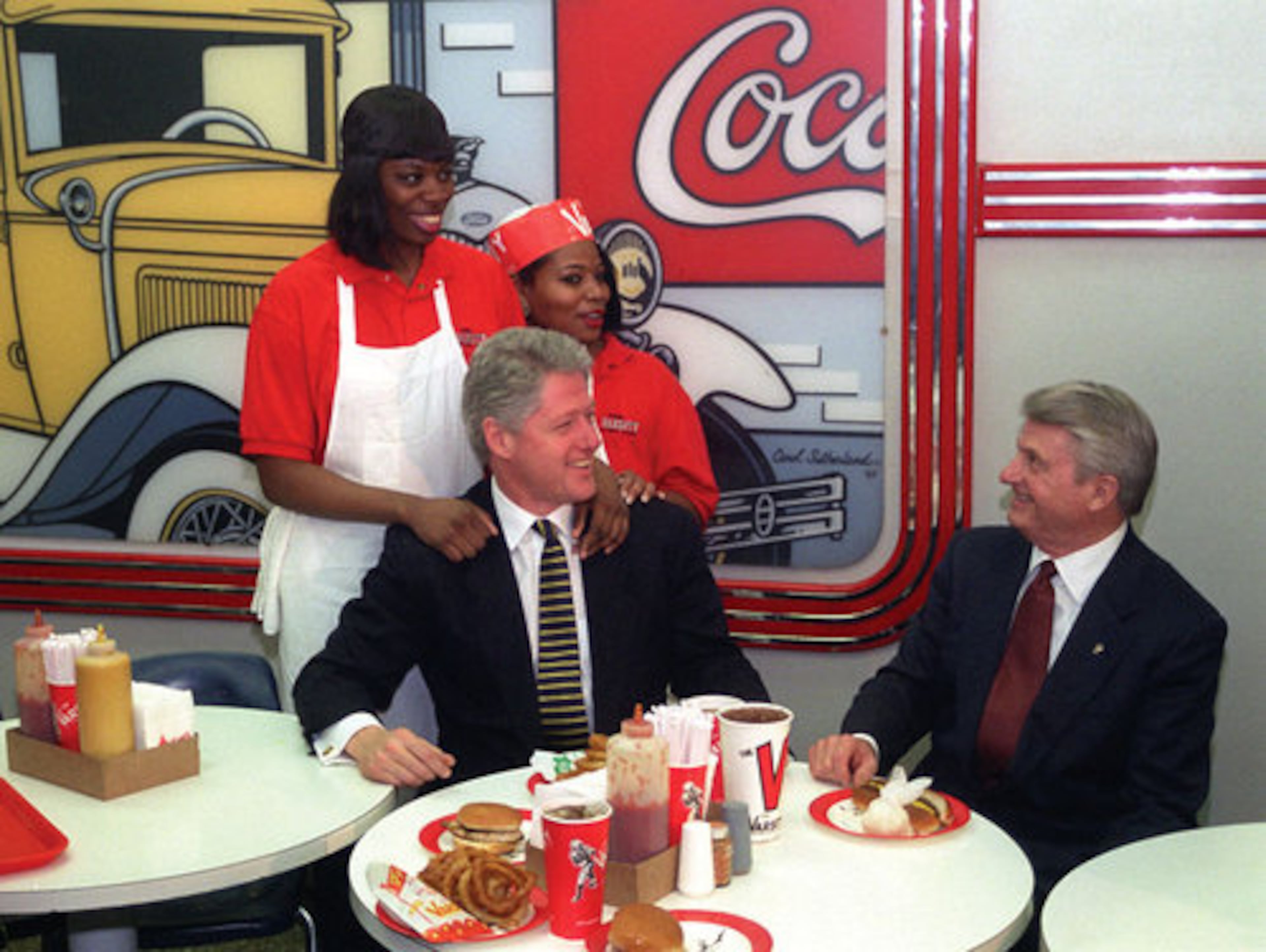 Then-President Clinton enjoyed a grilled chicken sandwich, french fries and a Diet Coke with governor Zell Miller when he visited The Varsity in January 1996. With them are employees Vanessa Dukes (left) and Yolanda Pleasant.