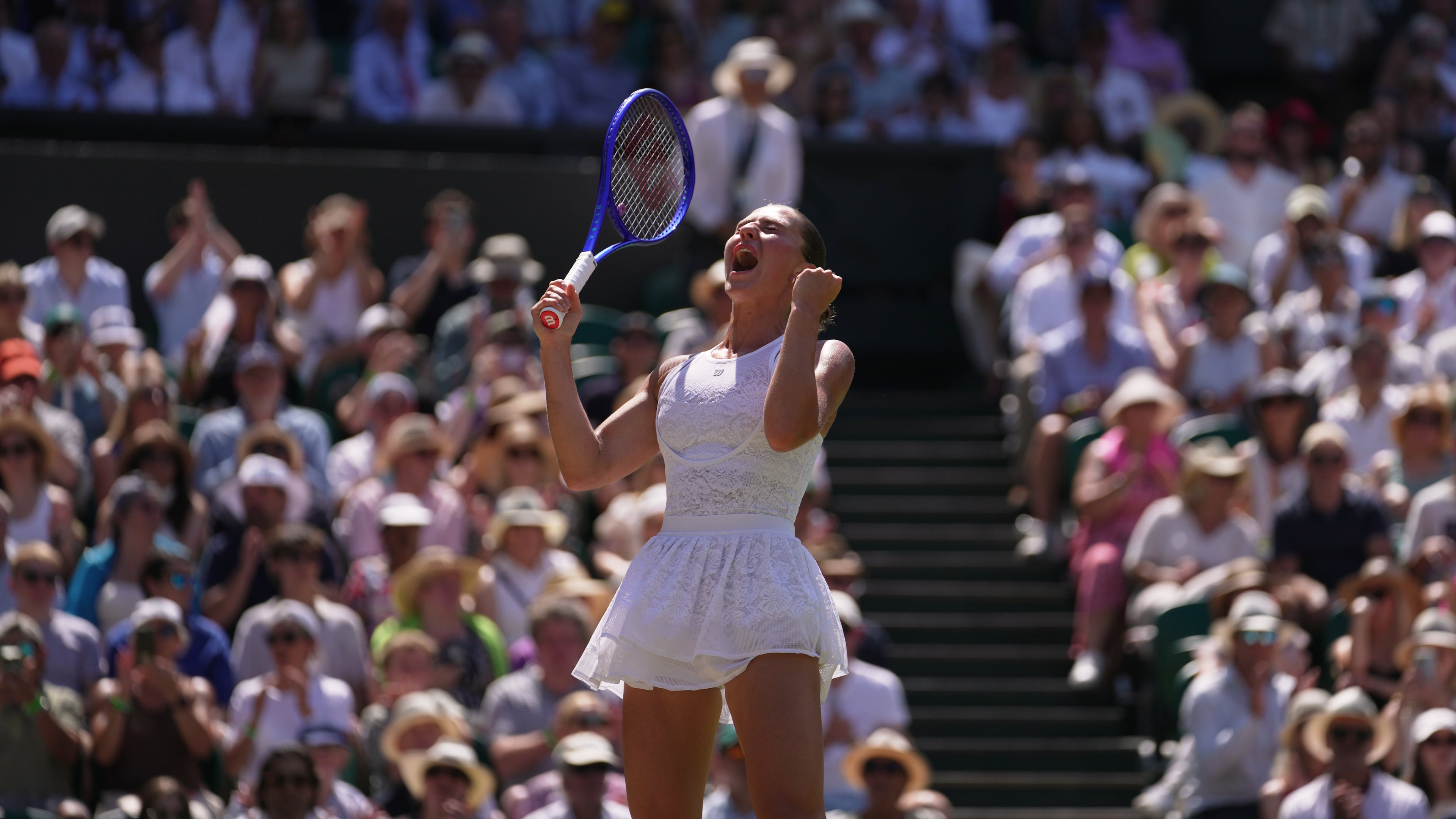 Marta Kostyuk of Ukraine celebrates her victory against Jasmine Paolini of Italy in their quarter-final women's singles match at the Wimbledon Tennis Championships in London, Wednesday, July 8, 2026. (AP Photo/Brian Inganga)