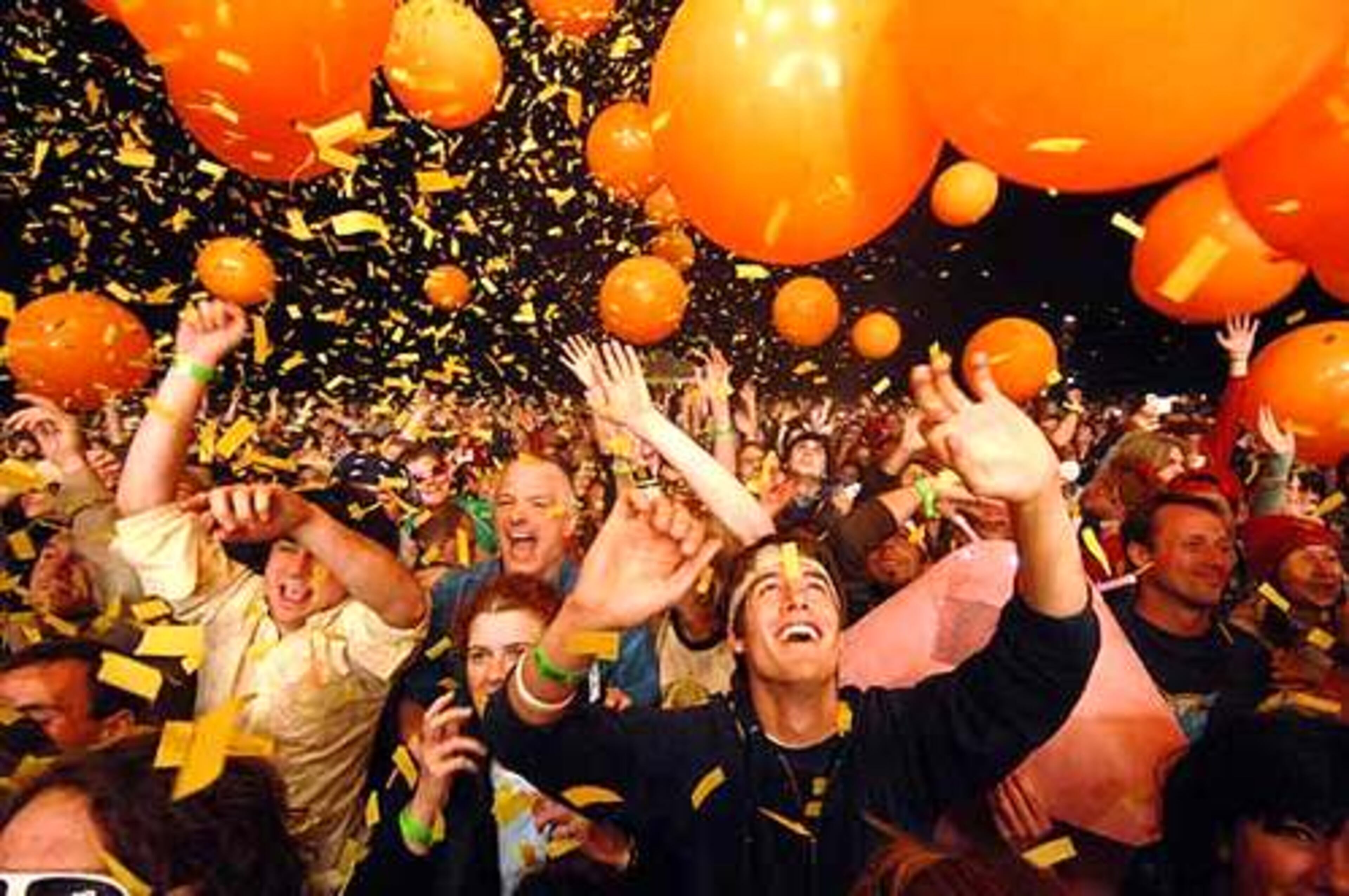 The crowd takes in the balloons and tons of confetti that were showered on them at the start of The Flaming Lips show.