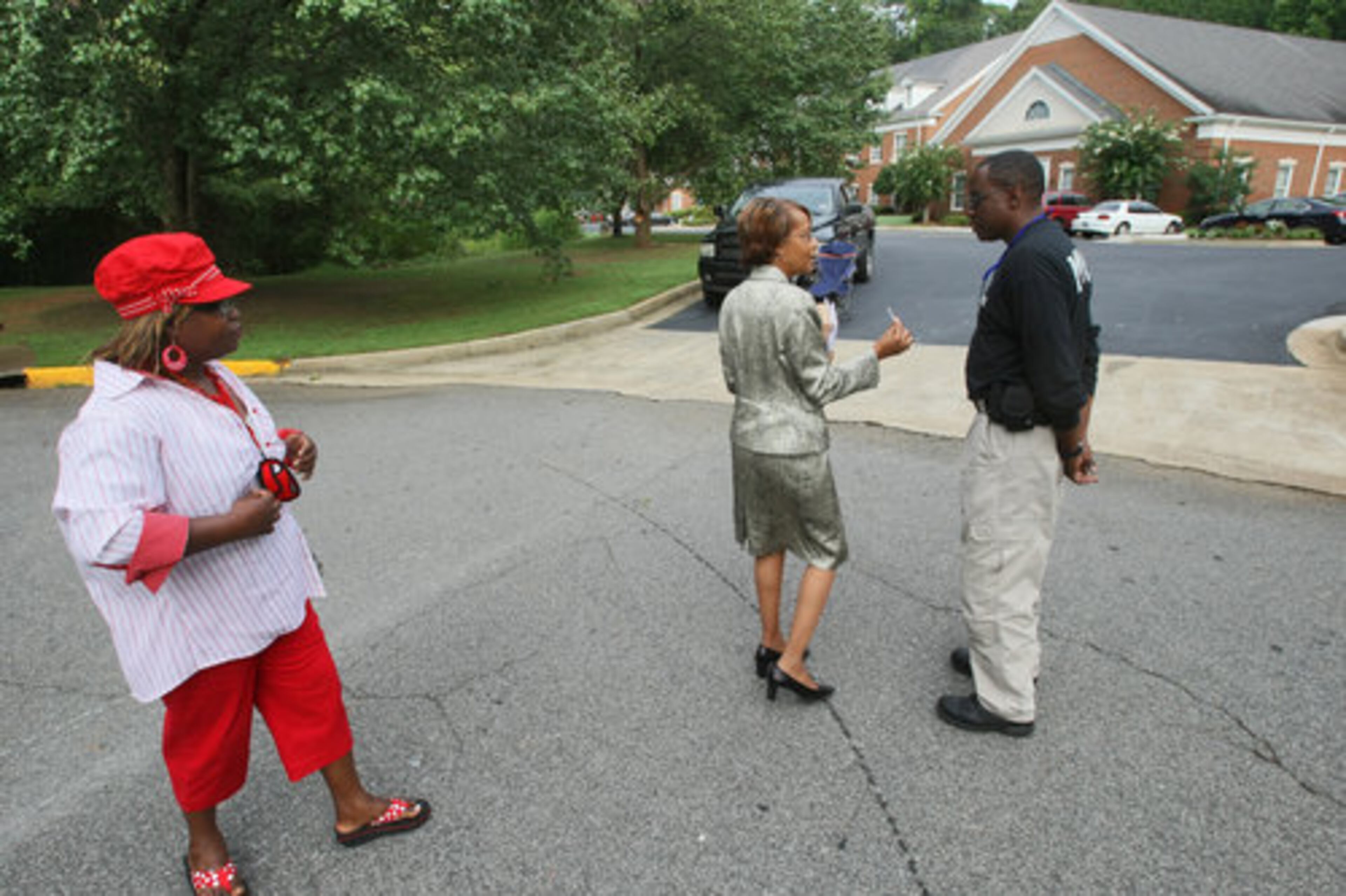 Clayton county concerned citizen, Linda Granger (left) and Clayton County school board-elect member Jessie Goree were stopped by a law enforcement officer outside the Association of Colleges and Schools office. before Thursday's meeting. Goree later was able to enter.