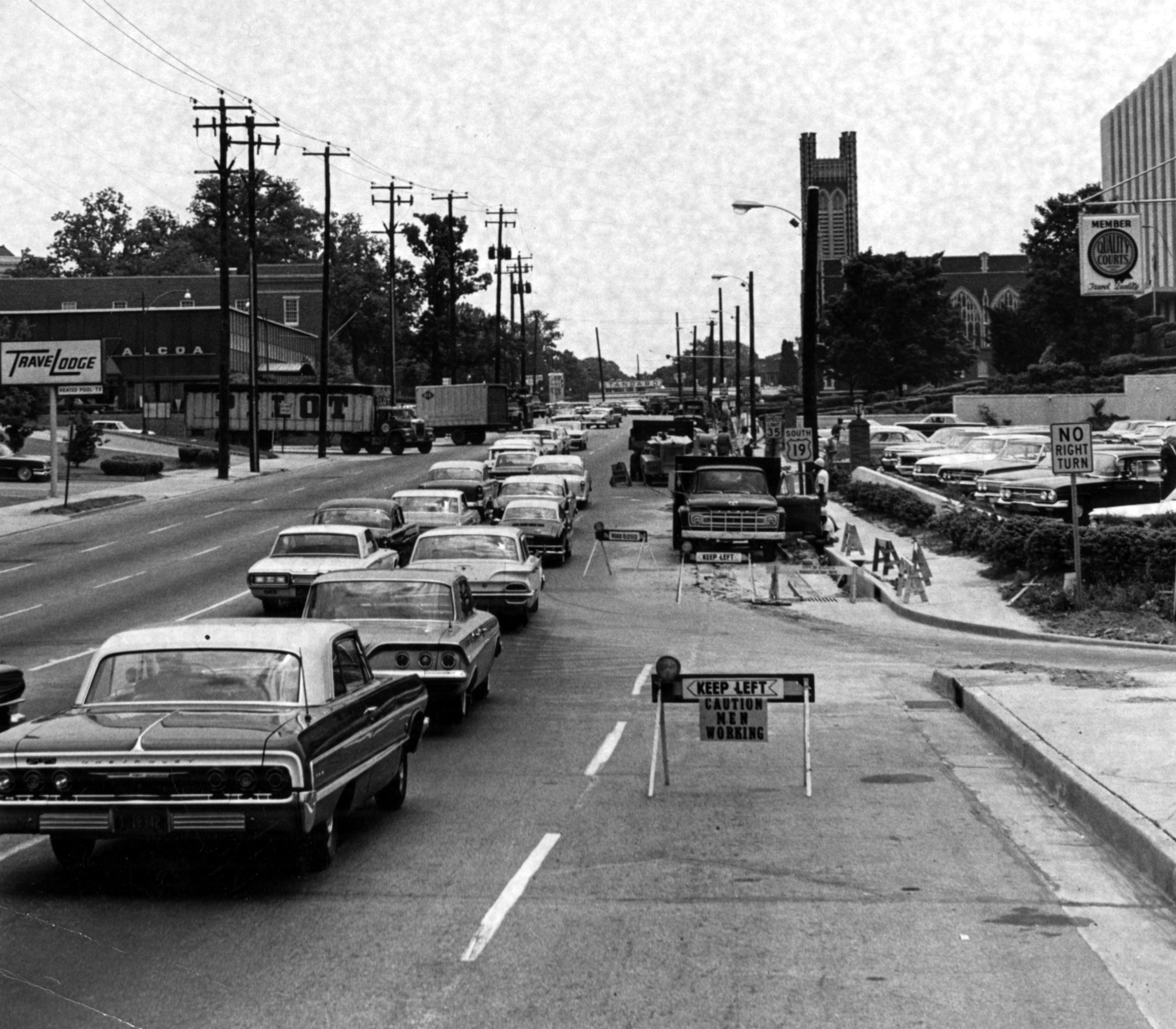 1964 - - This portion of Peachtree Street, near Brookwood Station, is in the process of being made wider by 8 feet, 4 inches on each side. A 1,000-foot stretch between Spring and the expressway (Brookwood Station) will be widened to provide three lanes in each direction, plus a turning lane.