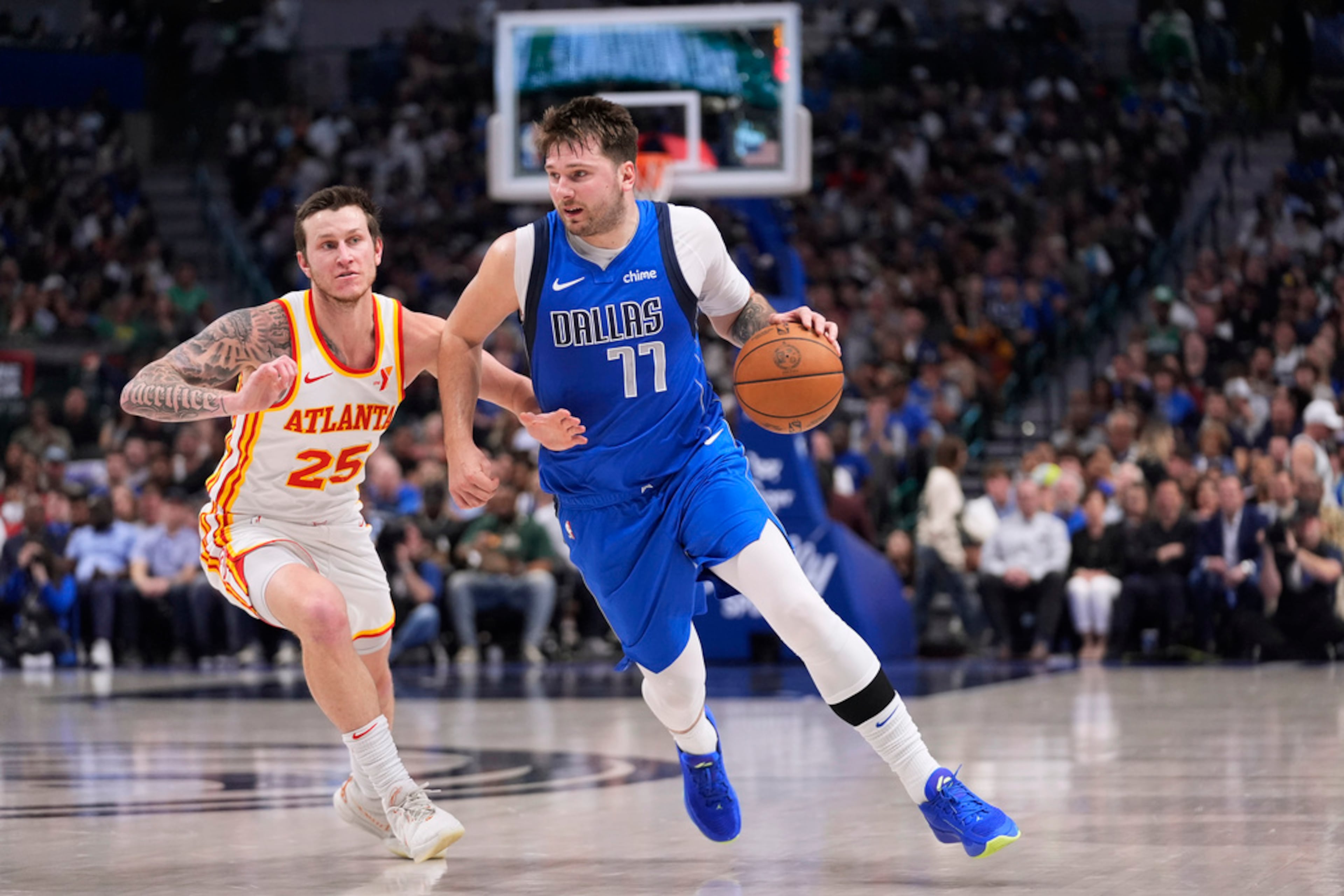 Dallas Mavericks guard Luka Doncic (77) drives against Atlanta Hawks guard Garrison Mathews (25) during the first half of an NBA basketball game in Dallas, Thursday, April 4, 2024. (AP Photo/LM Otero)