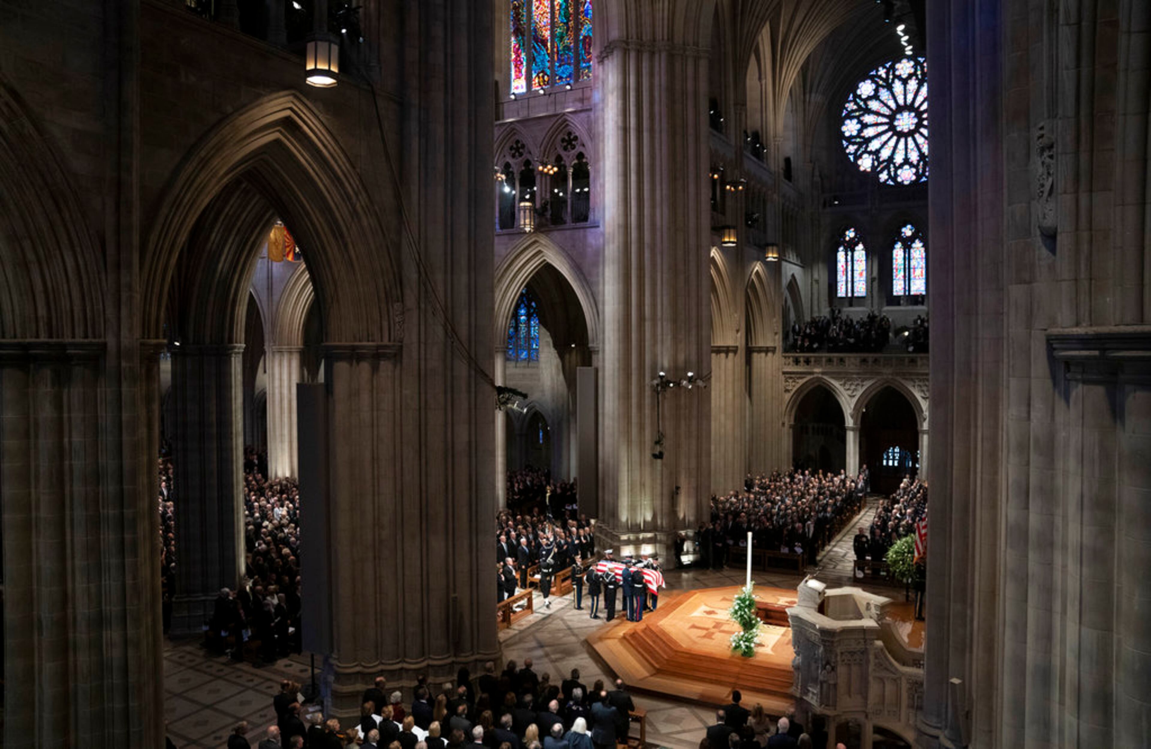 The flag-draped casket of former President George H.W. Bush is carried by a military honor guard during his State Funeral Service at Washington National Cathedral in Washington, Wednesday, Dec. 5, 2018. (AP Photo/Carolyn Kaster)